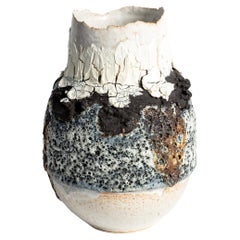 Open volcanic textured vase with cracked porcelain and lava stone