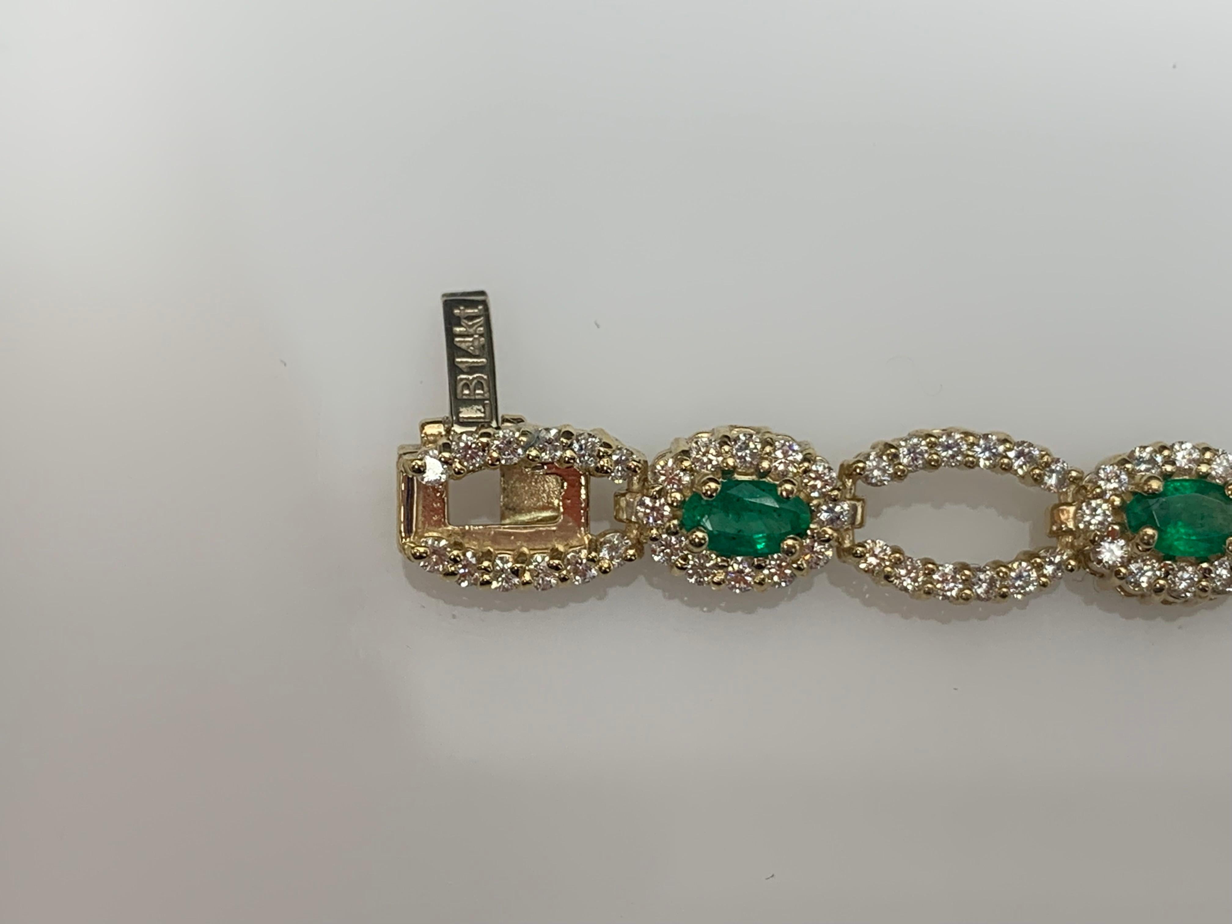 An antique Art Deco bracelet showcasing 10 oval cut emeralds weighing 2.13 carats. Surrounding the emeralds is a row of brilliant cut diamonds, set in an intricate open-work design made in 14k yellow gold. 240 Accent Diamonds weigh 2.85 carats