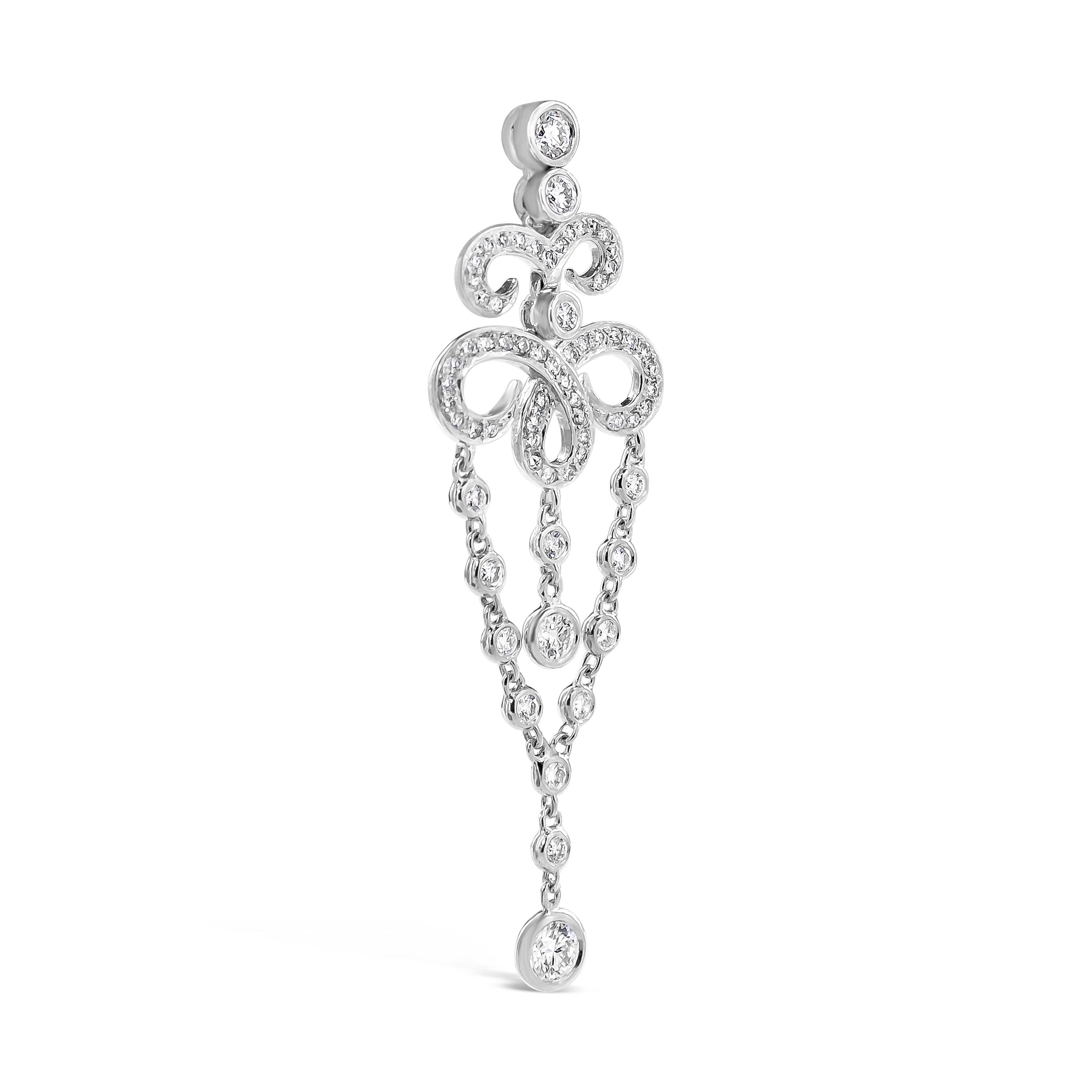 This fashionable pair of fringe dangle earrings showcases an open-work filigree design, encrusted with round diamonds, accented by suspending diamonds by the yard chain. Diamonds weigh 1.85 carats total.Made in 18K White Gold.

Style available in