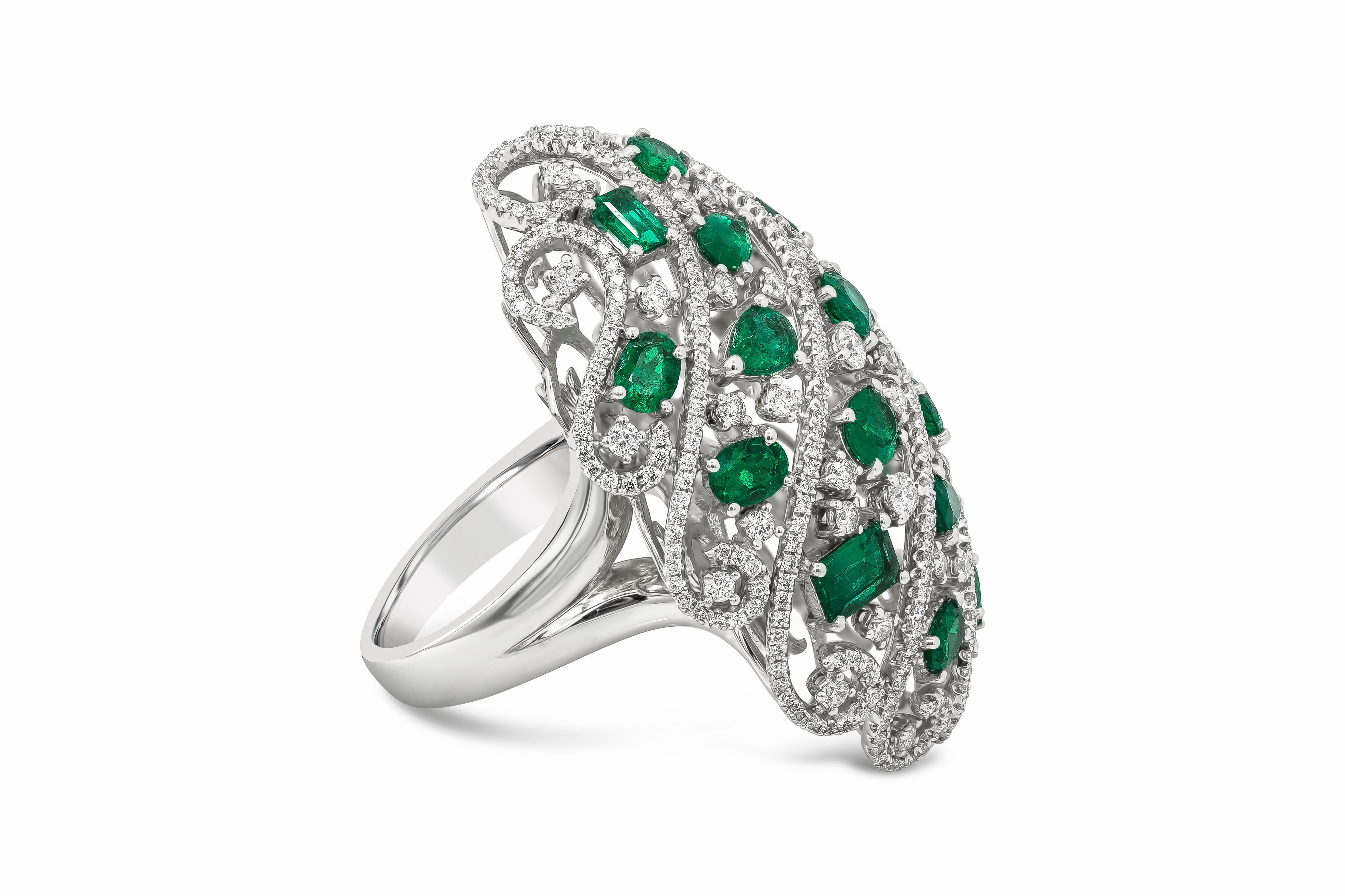 This well crafted fashion dome ring showcases 16 oval cut color-rich green emeralds weighing 3.98 carats total and 330 round brilliant diamonds weighing 2.18 carats total, set in a fashionable open-work dome style design. Finely made in 18k white