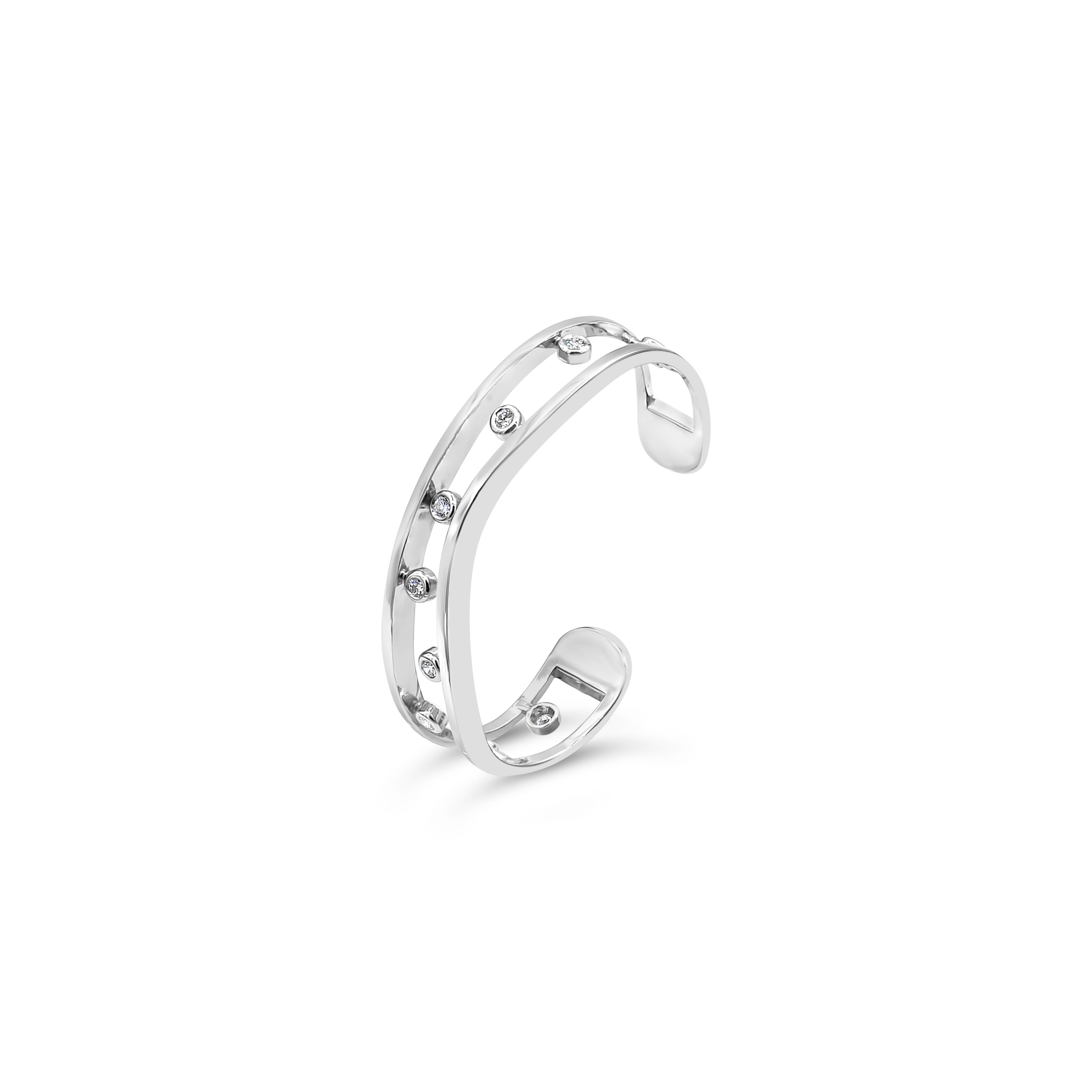 A simple piece of cuff bracelet showcasing bezel set round diamonds, set in a chic open-work design. Diamonds weigh 0.65 carats total. Bracelet weighs 15.70 grams. Made in 14K white gold. Small size and only fits a small wrist.

Roman Malakov is a