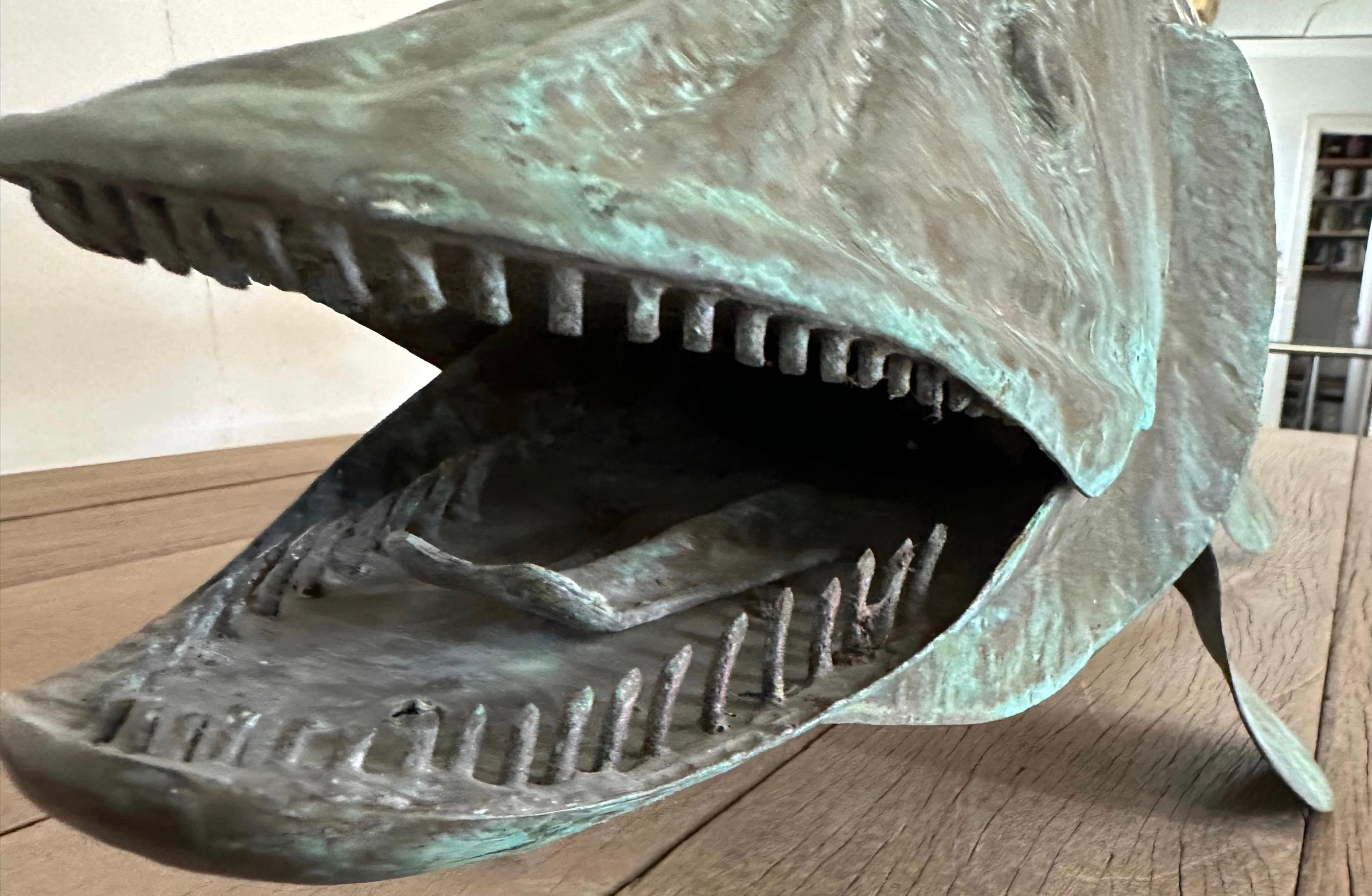 A fantastic 20th century copper barracuda was a part of a weather vane but now lacking the directional and the post but will make a wonderful sculpture with weathered verdigris patina and details.
The fish form weathervane made with hammered copper