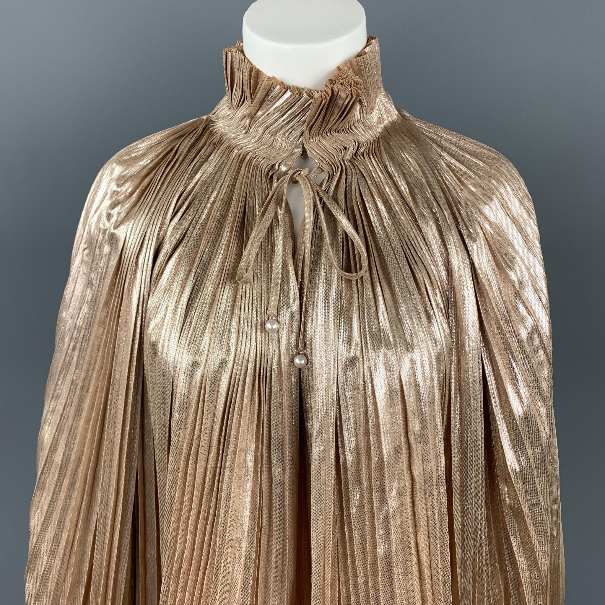OPENING CEREMONY blouse comes in a gold metallic pleated polyester featuring a high collar, balloon sleeves, hook & loop, and front beaded drawstring detail.

Very Good Pre-Owned Condition.
Marked: 10

Measurements:

Shoulder: 17 in.
Bust: 40