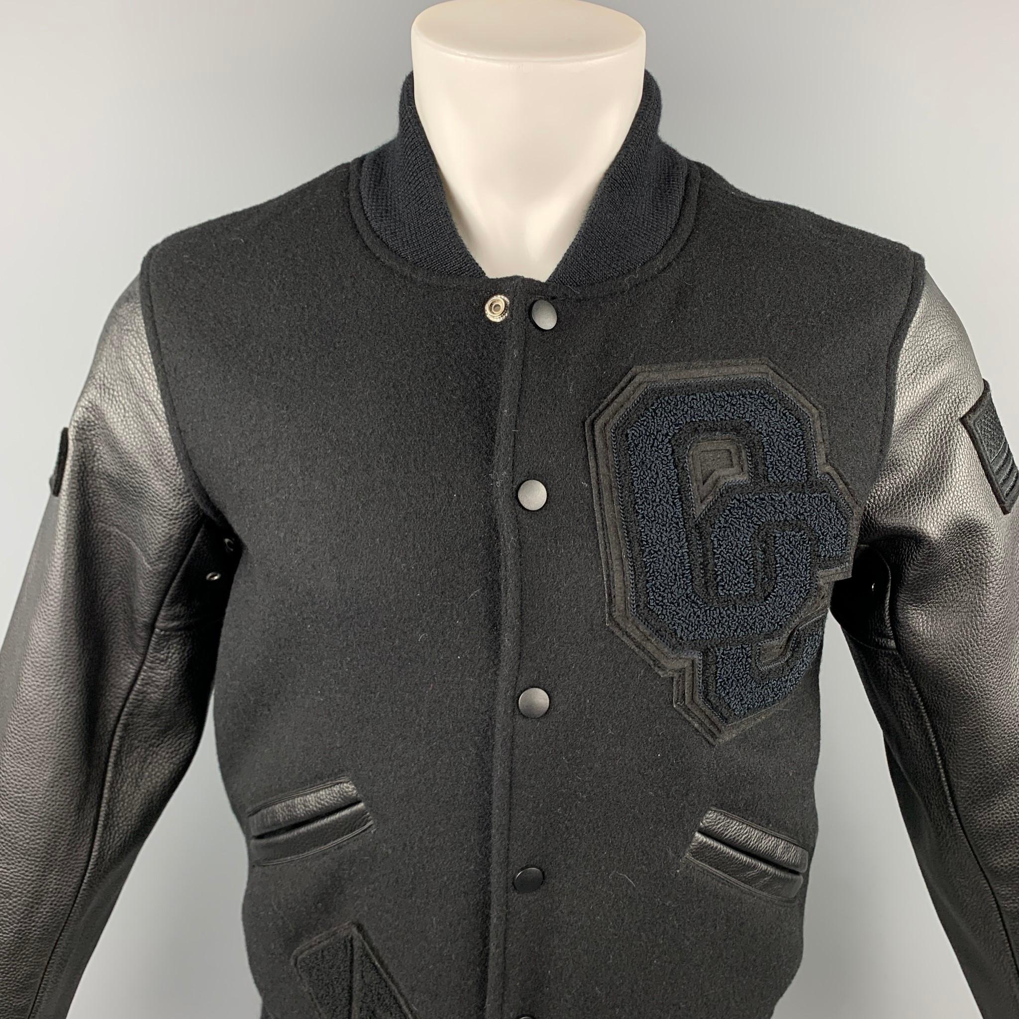 OPENING CEREMONY jacket comes in a black wool with leather sleeves featuring a varsity style, patch details, full liner, slit pockets, and a snap button closure. 

Very Good Pre-Owned Condition.
Marked: XS

Measurements:

Shoulder: 18 in.
Chest: 38