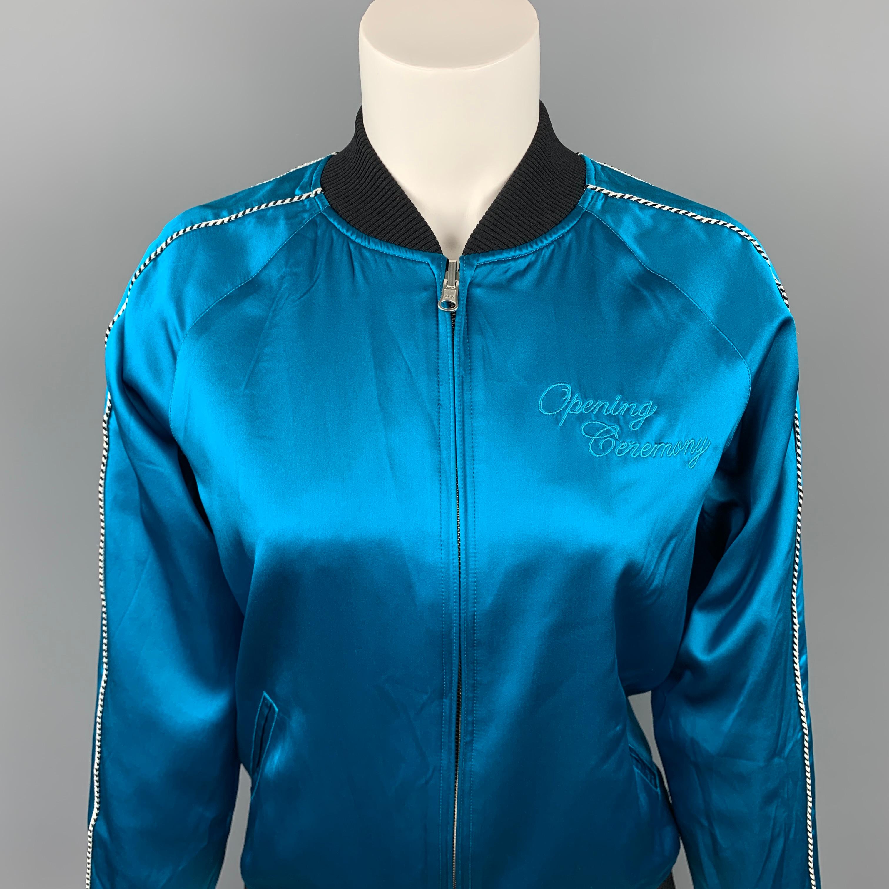 OPENING CEREMONY jacket comes in a aqua silk featuring a reversible style, ribbed hem, embroidery detail, slit pockets, and a zip up closure. 

Very Good Pre-Owned Condition.
Marked: XS

Measurements:

Shoulder: 17 in.
Bust: 38 in.
Sleeve: 23