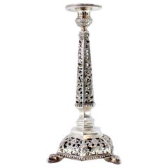 Openwork silver candlestick with hexagonal base and carved obelisk wall light Openwork silver candlestick with hexagonal base and carved obelisk wall light
