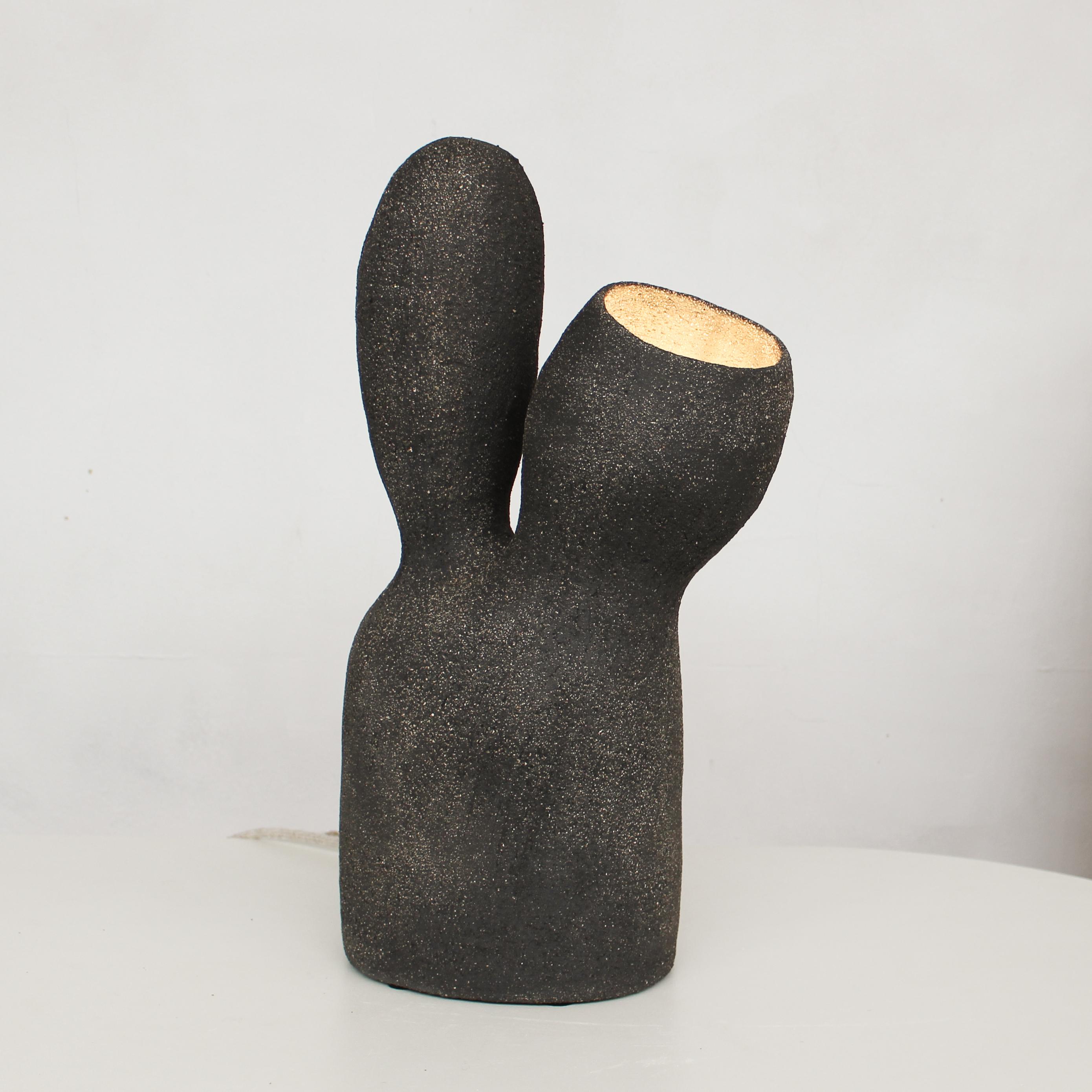 Opéra black stoneware table lamp by Elisa Uberti
Materials: Black stoneware
Dimensions: 50 x 27 x 16.5 cm

After fifteen years in fashion, Elisa Uberti decides to take the time to work with these hands and to give birth to new projects.

Designer