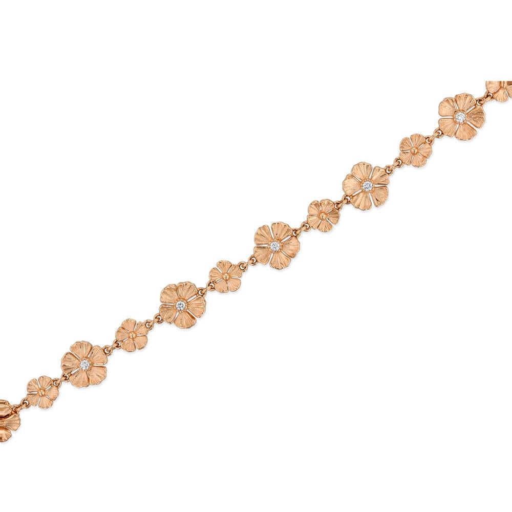 An extraordinary necklace comprised of alternating larger and smaller 18k rose gold flowers.  The larger flowers have a tiny diamond on both sides.  The 32 inch necklace can be worn long or doubled up.  The clasp is also a flower, just slightly