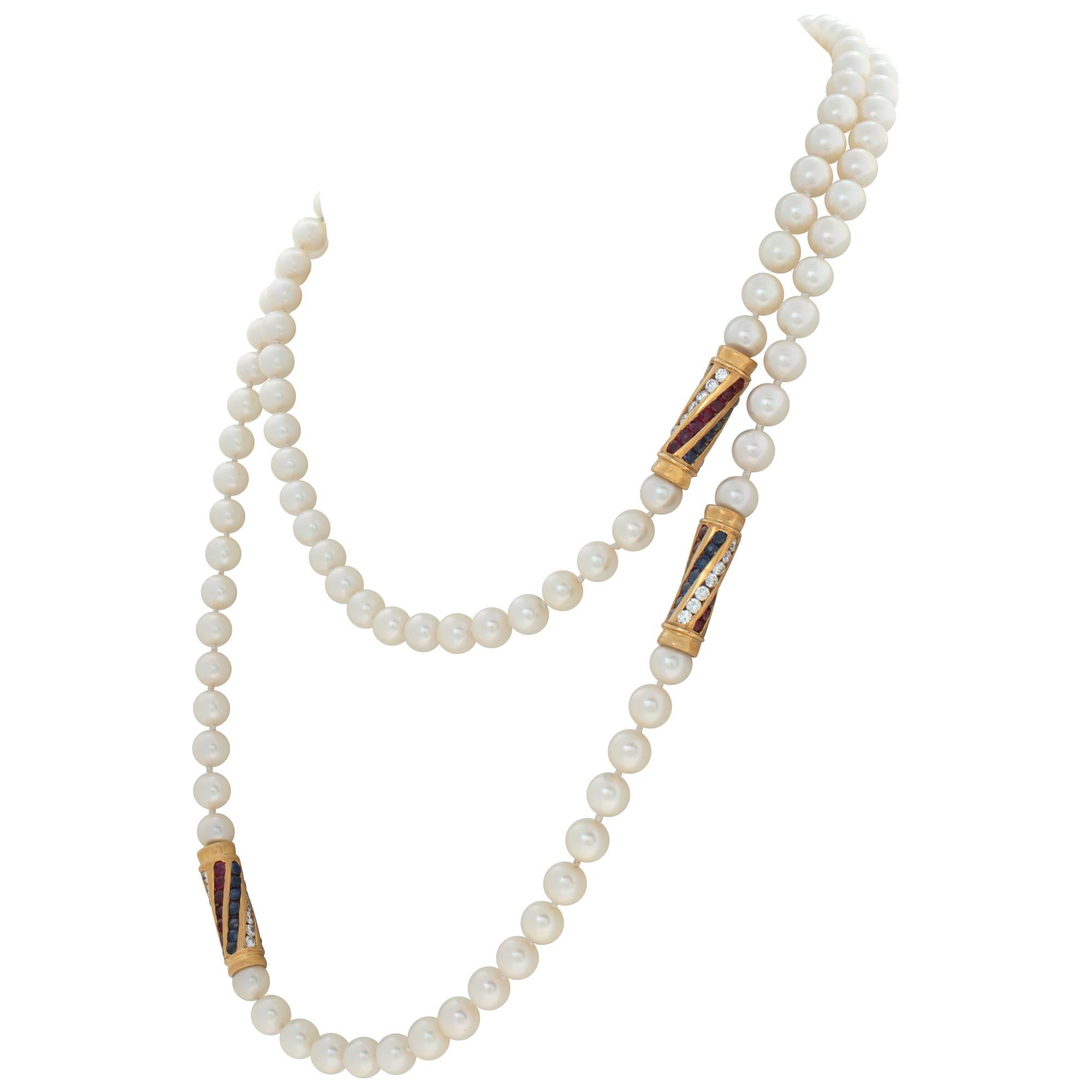 Opera length (36 inches) 6 x 6.5mm Akoya pearls necklace with four gold stations swirling with diamonds, rubies and sapphires set in 18K yellow gold to complete the glamour look. Diamonds approx. carat weight 2 carats G-H color, VS clarity. Necklace