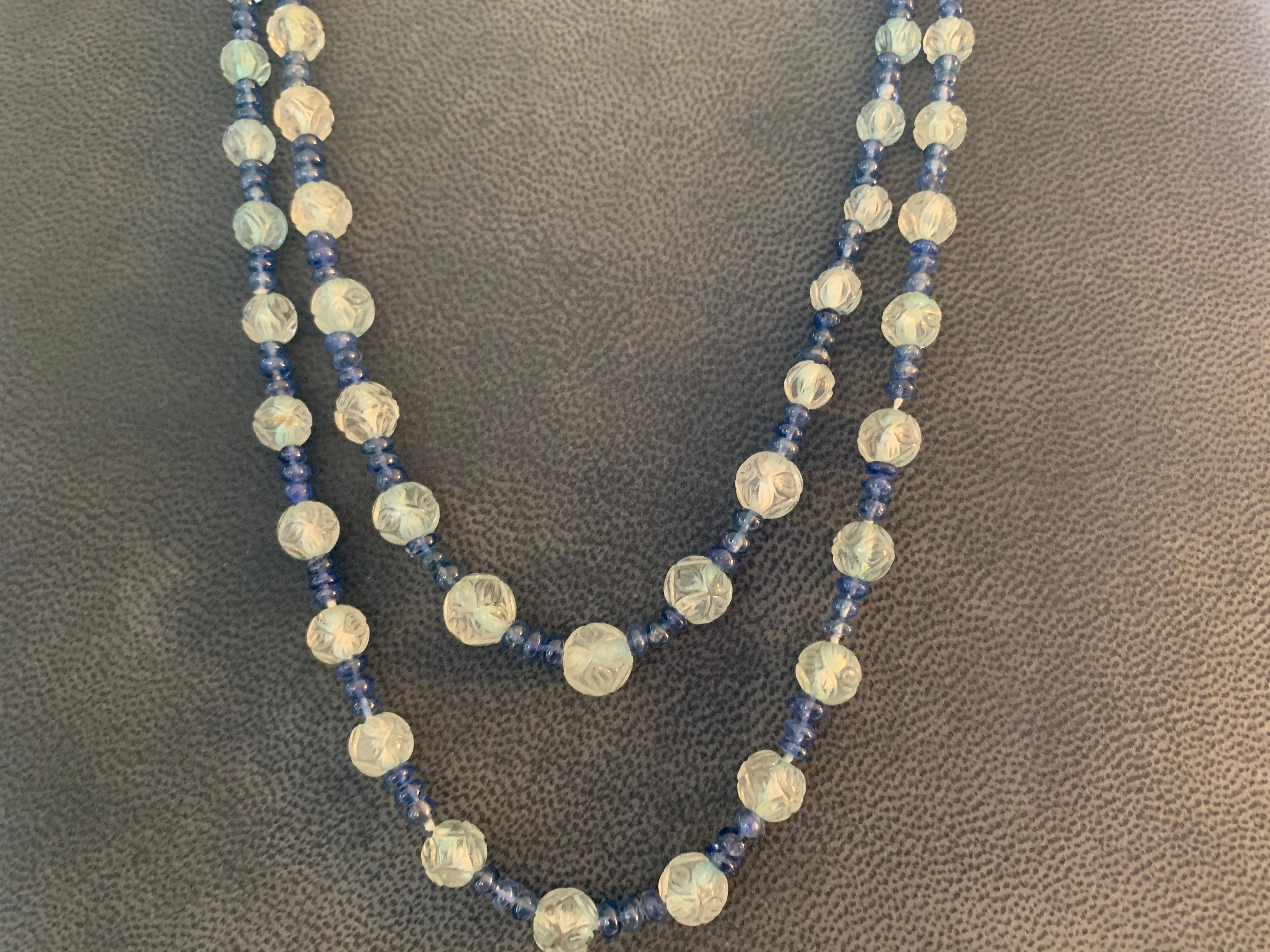 Opera Length Carved Aquamarine and Sapphire Bead Necklace 

2 strand necklace with 144 carved aqua beads approx 274 ct and 348 sapphire beads app 70.00 ct 

Platinum and Sappphire clasp
