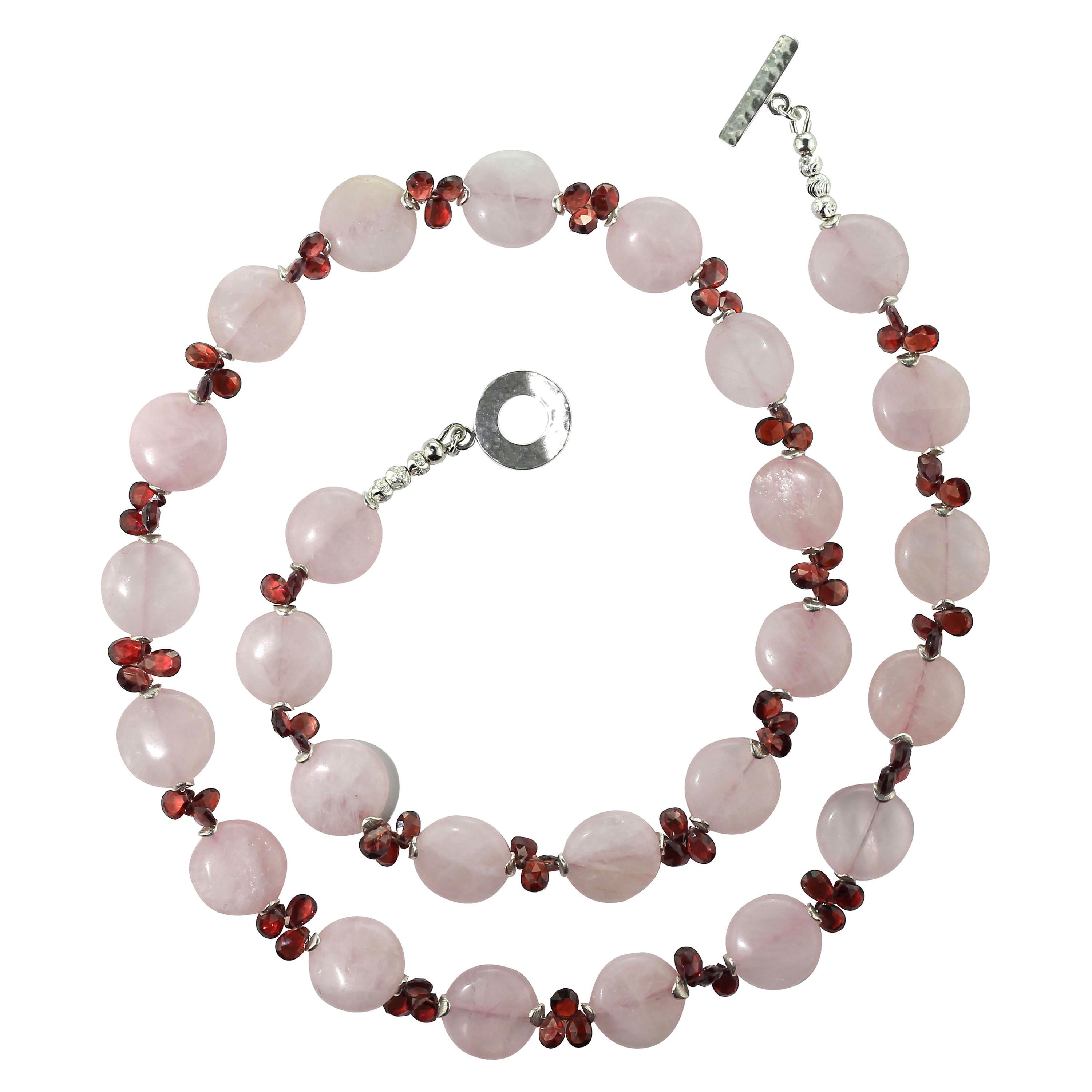 
This is an elegant, unique necklace of sparkling faceted Garnet 6 MM briolettes fluttering between warm glowing round discs of 16 MM Rose Quartz. Silver tone flutters and a Sterling Silver toggle clasp finish this lovely necklace. Wear this warm 27