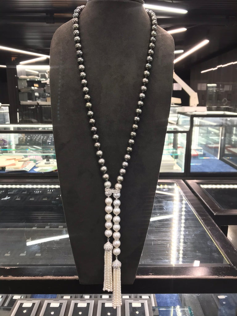 18K White gold graduating necklace featuring 80 ombre pearls of white South Sea and Tahitian measuring 8.9-12.2 mm with a diamonds clasp and diamond spaces weighing 3.70 carats. 
Clasp can be moved. 
Color G-H
Clarity SI