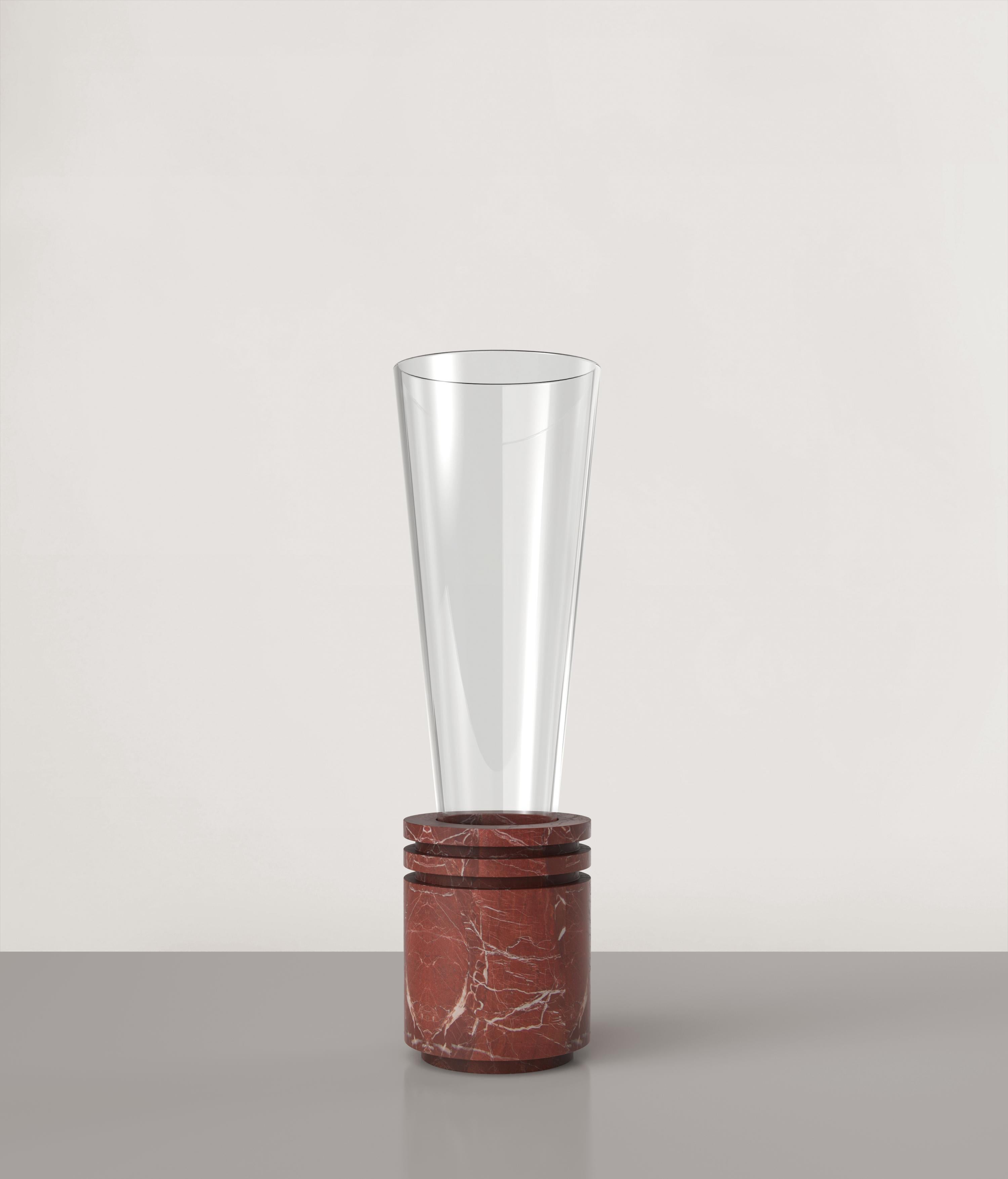 Opera V2 vase by Edizione Limitata
Limited edition of 150 pieces. Signed and numbered.
Dimensions: D12 x H40 cm
Materials: Rosso Balmoral + shiny glass
Also availailable in different colours.

Opera is a 21st Century collection of sculptural
