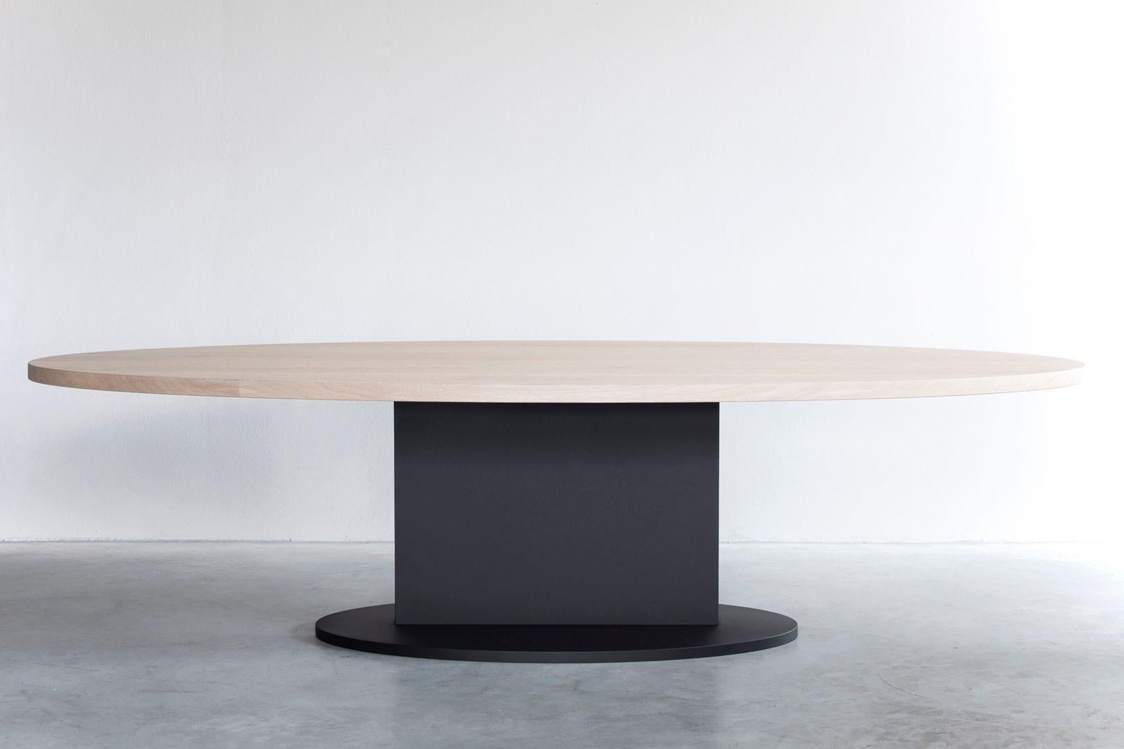Opium oval table with steel base by Van Rossum
Dimensions: D240 x W120 x H75 cm
Materials: Oak, steel.
Also available with brass details.

The wood is available in all standard Van Rossum colors, or in a matching finish to customer’s own