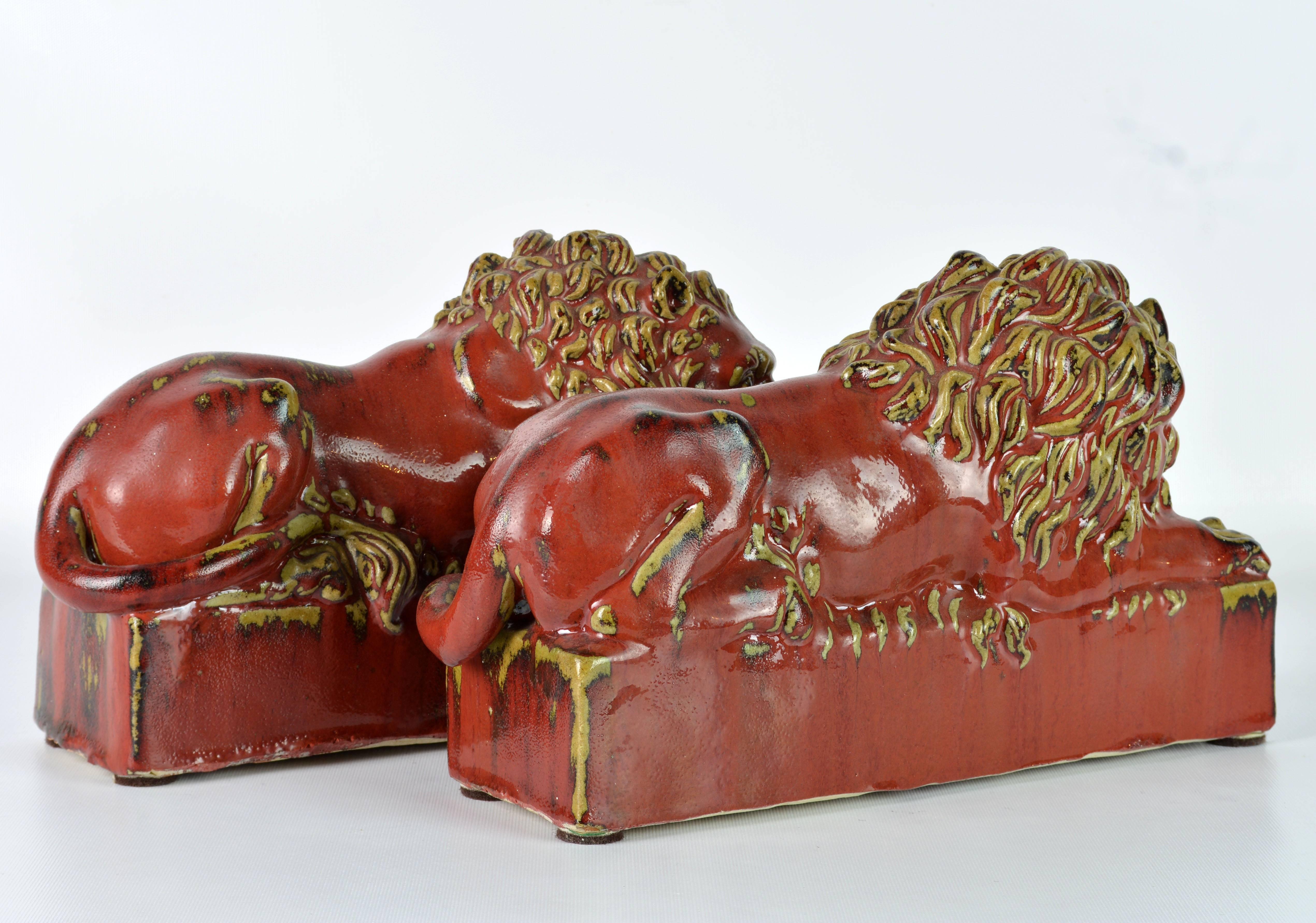 Opposing Pair of 20th Century Oxblood and Celadon Glazed Ceramic Resting Lions In Excellent Condition In Ft. Lauderdale, FL