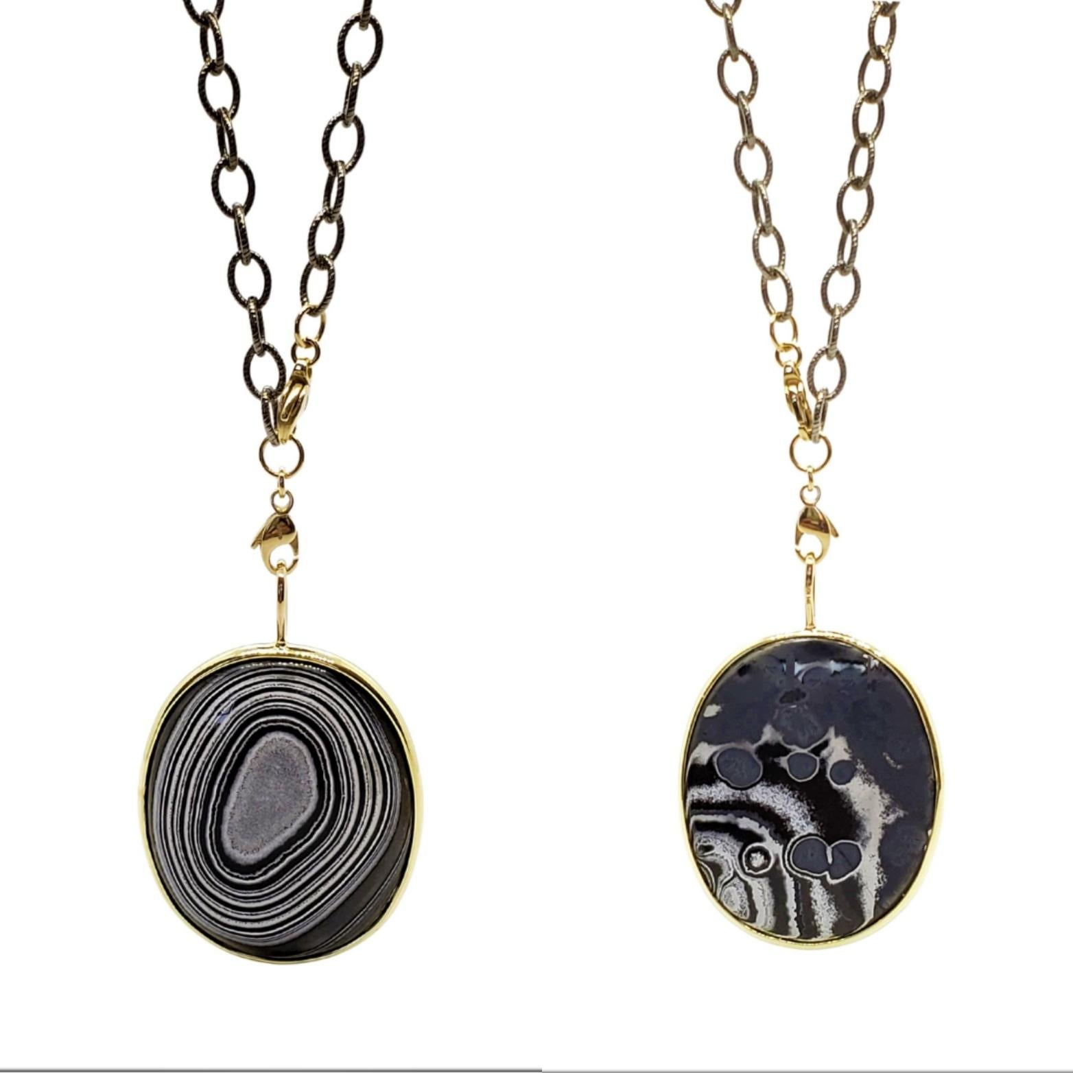 Edgy bold round Oval gemstone Necklace in 14K yellow gold. Mexican Psilomelane has an optical illusion aspect in the concentric pattern in Black and White. Every piece is a One of A Kind.
We handmake the bezel for each stone which is reversible. Our