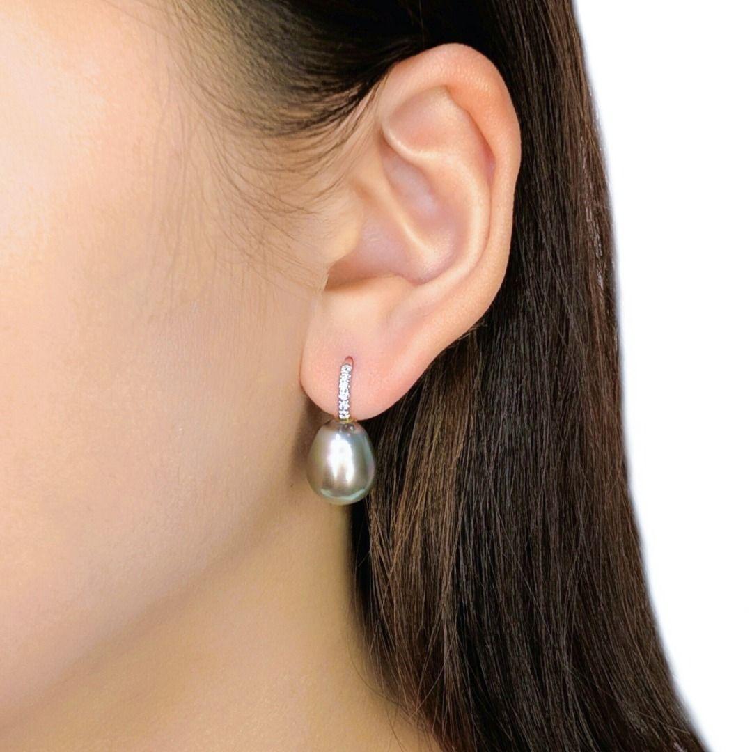 Adorn your ears with the exquisite elegance of these stunning hook earrings, meticulously crafted in radiant 18K white gold. Each earring features a magnificent South Sea pearl, ranging from 11mm to 11.2mm in diameter, renowned for its rare and