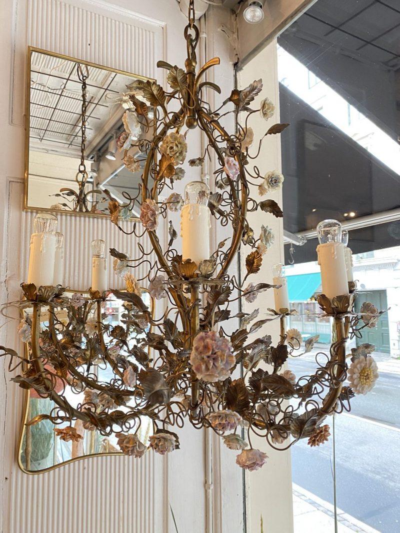 Opulent French metal chandelier, from around the 1930s, with countless beautiful porcelain flowers and foliage, all in wonderful abundant delicate soft pastel hues.

This lovely ceiling lighting has 6 pipes for electricity and will look fantastic in