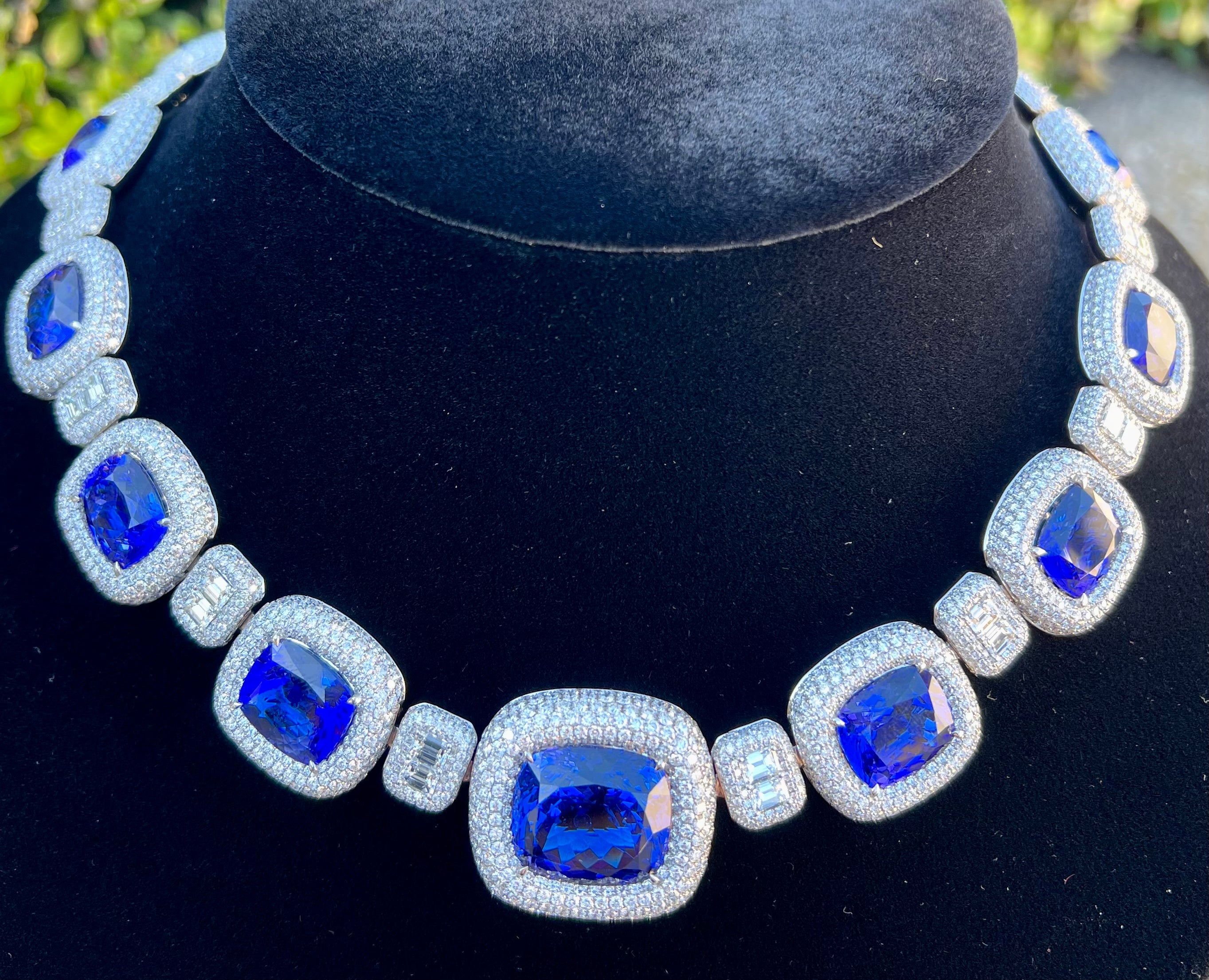 Magnificent, very noteworthy and extremely opulent in real life, intense blue color with a hint of violet, finest gem quality AAAA grade cushion cut tanzanite and diamond necklace is prong set in 18 karat white gold and has a combined total carat