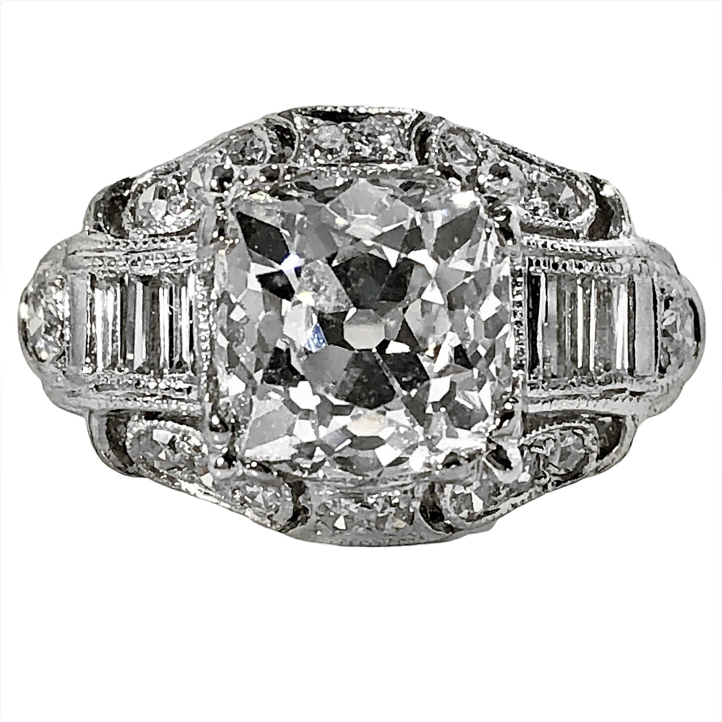 This wonderful and excellently preserved original Art-Deco creation is outstanding in appearance and in quality. Crafted in platinum almost 100 years ago, it is set with one very symmetrical antique cushion cut diamond weighing exactly 2.98ct, and