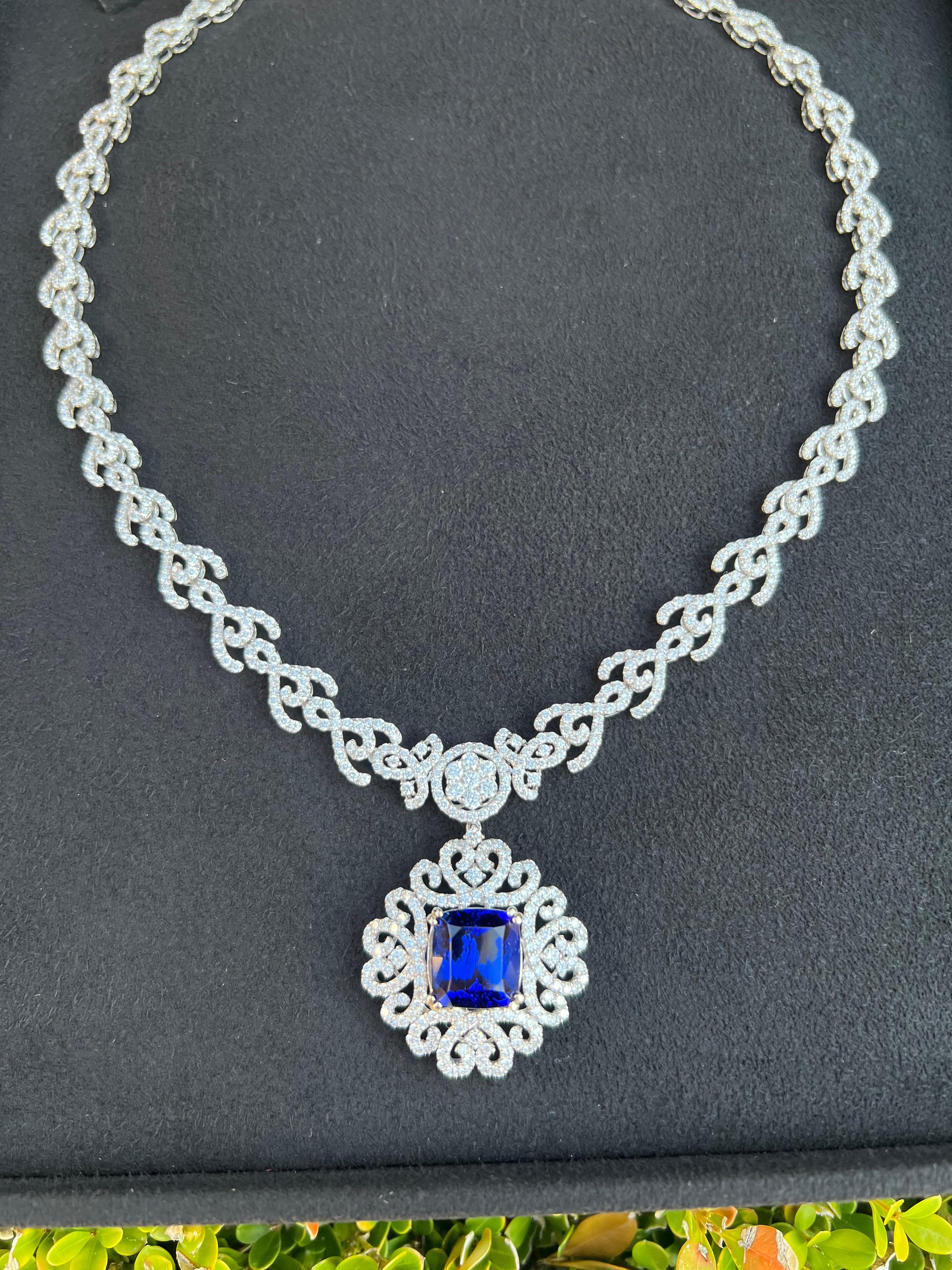 Magnificent, very dazzling and opulent in real life, intense blue color with a hint of violet AAAA grade cushion cut tanzanite and diamond necklace is talon prong set in 18 karat white gold and has a combined total carat weight of approximately