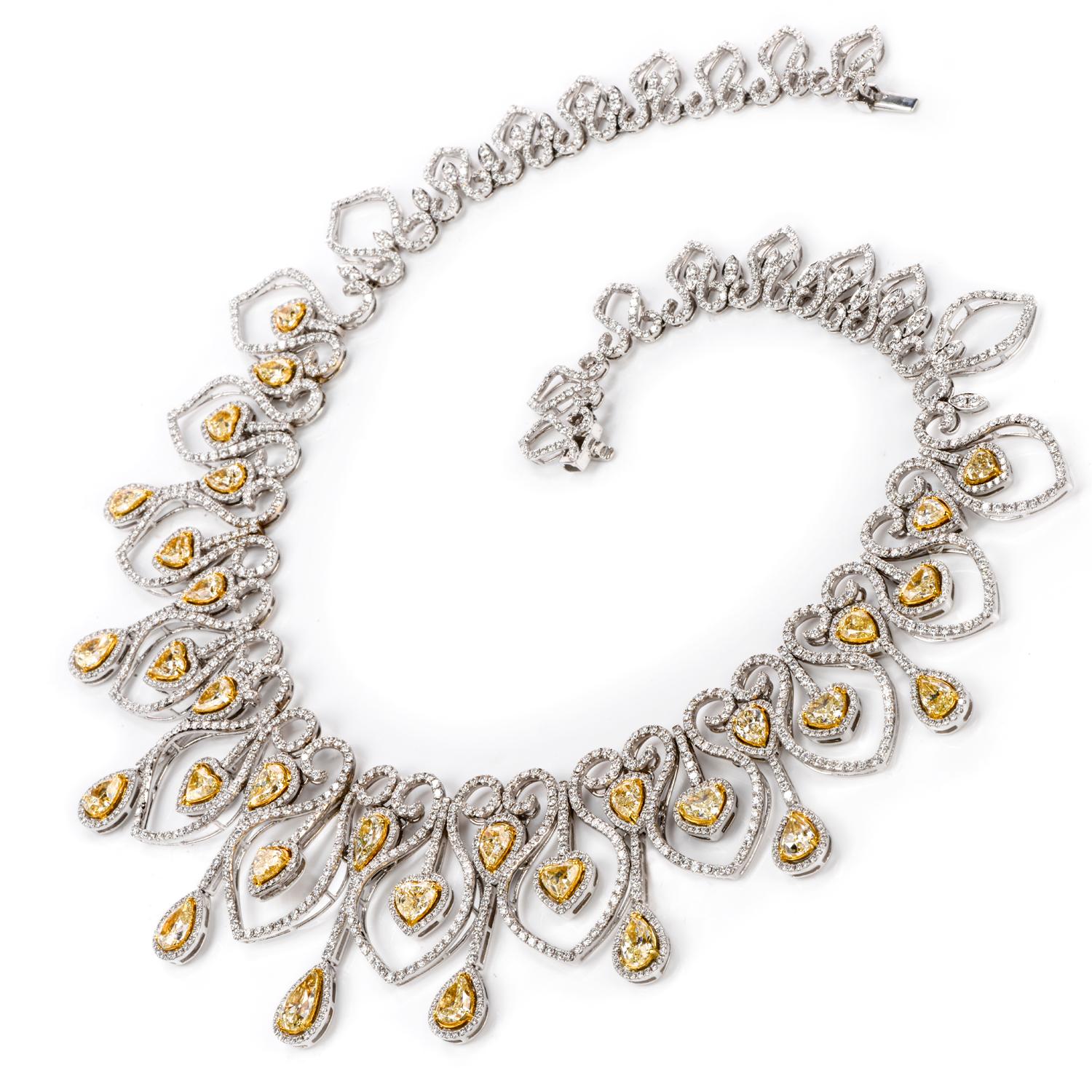MAKE YOUR STATEMENT with this opulent, chandelier inspired

16.5 inch choker necklace.

Featuring 12 heart shaped natural yellow Diamonds and 20 pear shaped yellow Diamonds

accenting throughout a sea of approximately 2503 icy white round faceted