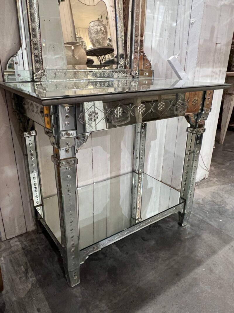 Spectacularly beautiful mirrored console table, in Venetian style, from France circa 1920s.

This piece has a stunning lower part including a drawer. All surfaces are mirror-covered, with faceted mirror glass and small glass rosettes.

On the