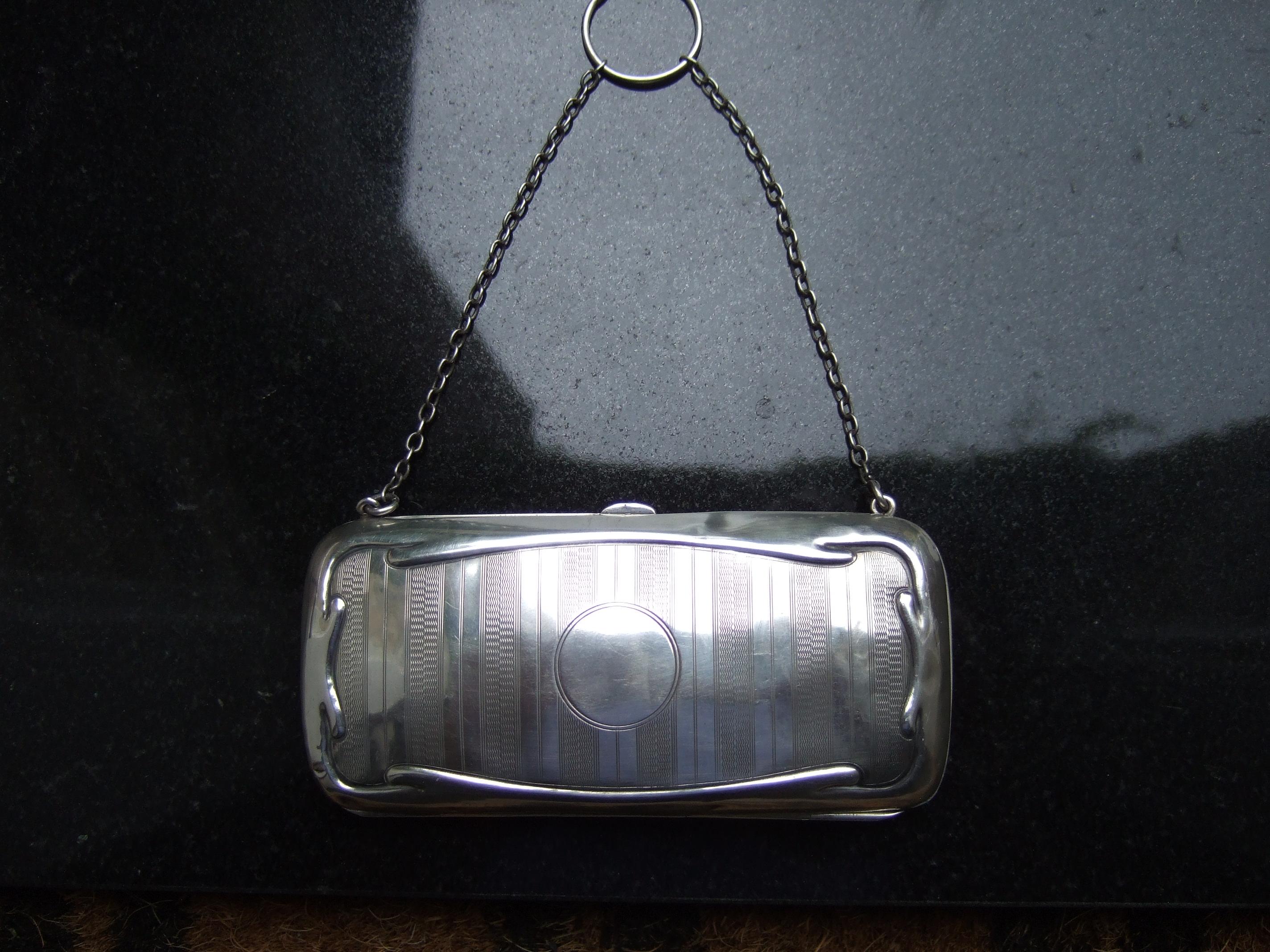 Opulent sterling silver diminutive tiny English antique evening bag c 1916
The elegant small size purse is designed with etched vertical stripes
on both exterior panels

The front sterling panel is designed with a smooth blank circle that
could be