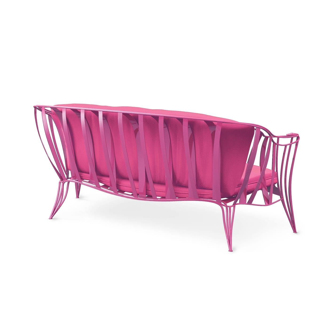 Romantic and airy, this garden sofa by Carlo Rampazzi will add a glamorous accent to any outdoor space. Its enveloping iron frame is bent by hand and enriched with a special rust-resistant treatment allowing the vivid fuchsia lacquer to preserve its