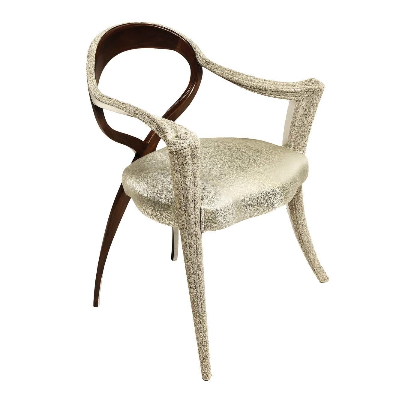 Part of the Opus Futura collection of superb and eclectic seating options, this chair will be a striking addition to a contemporary dining room, entryway or study. Its dynamic silhouette combines front legs and armrests in carved wood with White