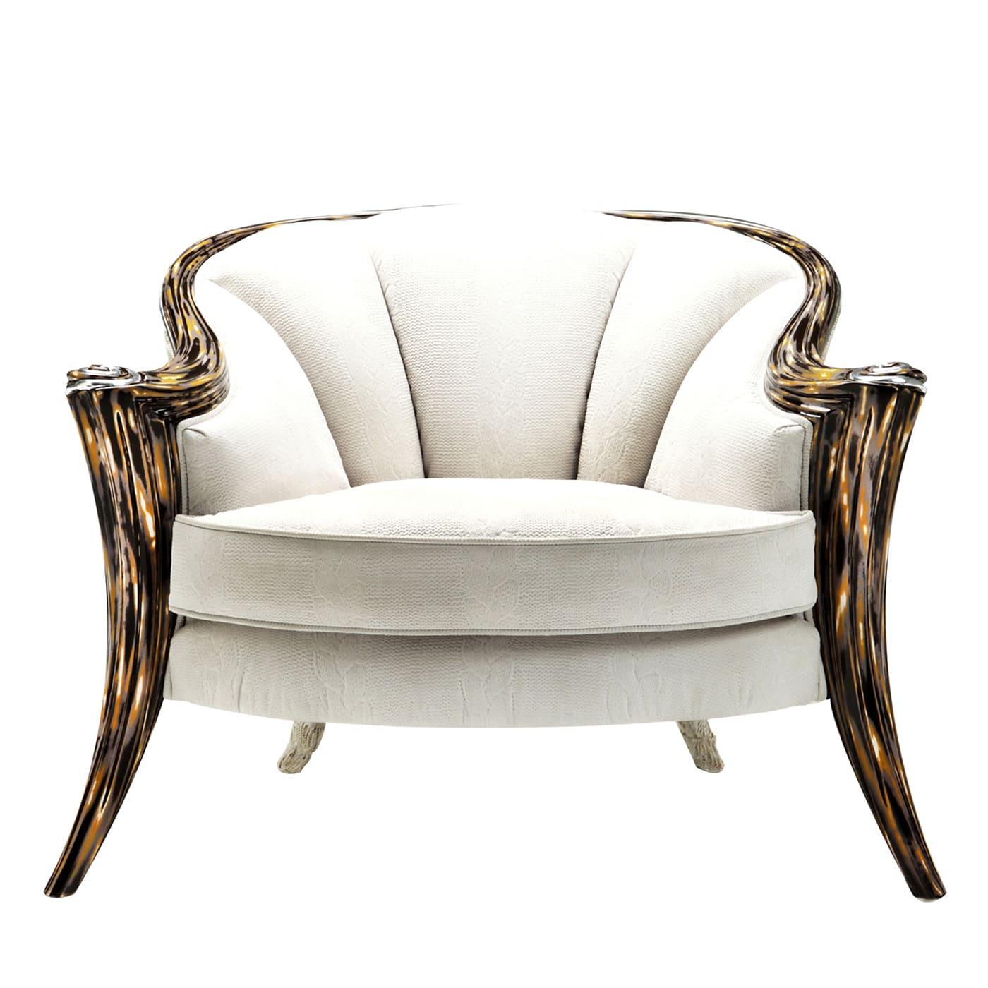 Sitting on this armchair or simply looking at it will equally distill a sense of unattainable exclusivity. The sculpted and sinuous wooden frame boasts the colorful Crazy Glass finish on the front legs, while the back is enriched with fringes and