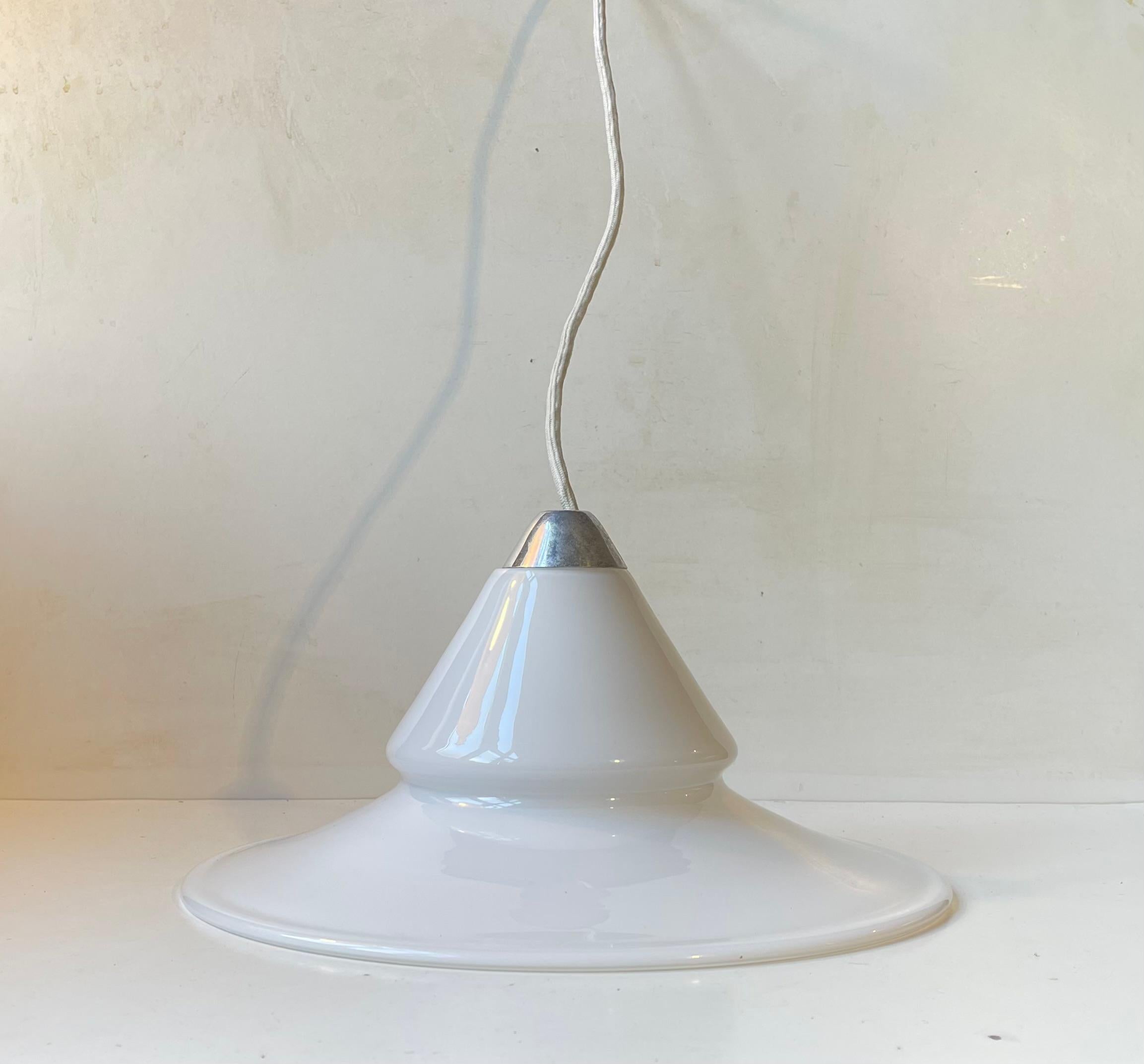 A rare hanging lamp called Opus. It was designed by Torben Jørgensen and manufactured by Royal copenhagen in Denmark during the 1980s. The glass shade was commissioned from Holmegaard and is handblown. This light comes installed with 3 meters new