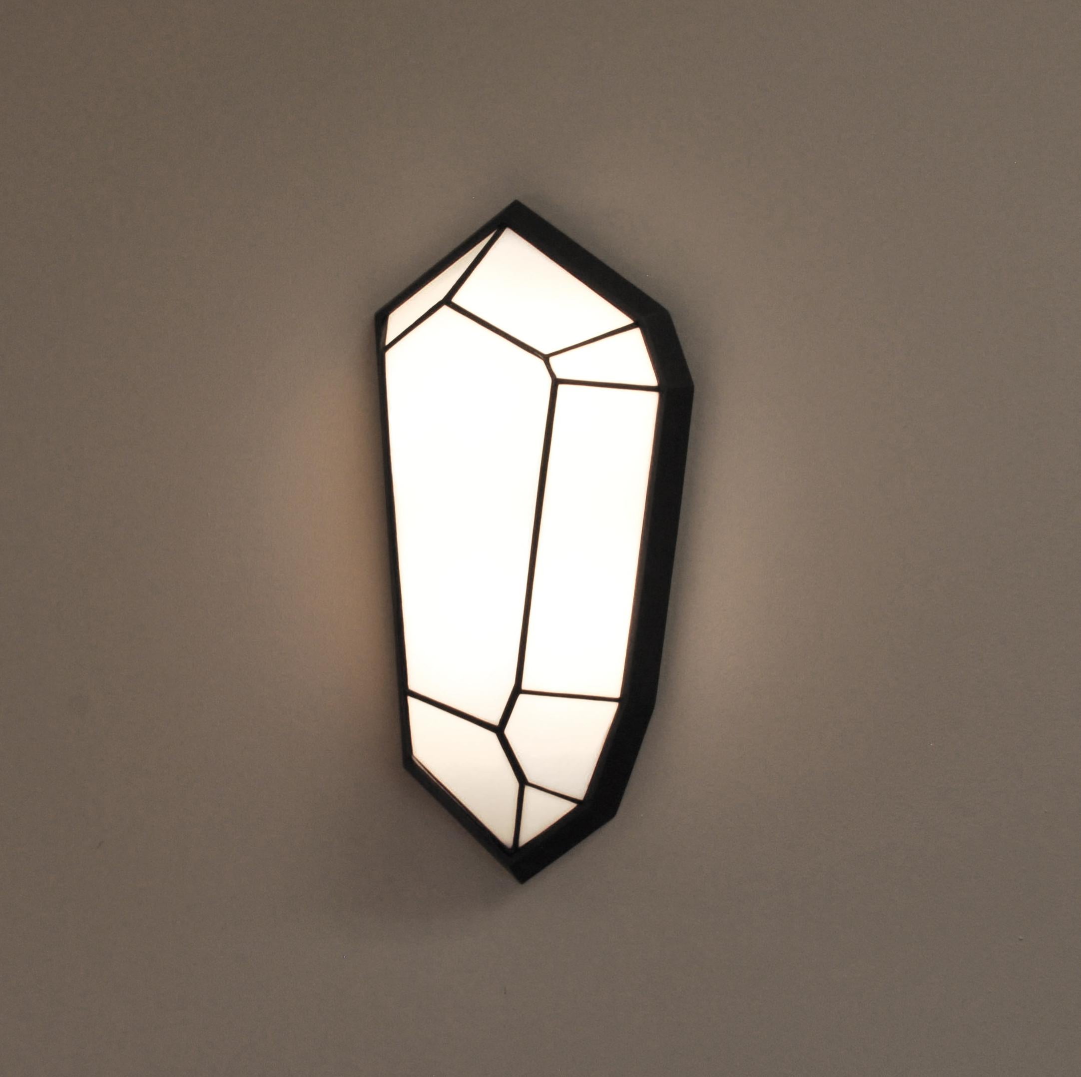 The Oracle sconce was inspired by raw quartz crystal formations. “The faceted surfaces of the crystals combine in such strong geometry while organic at the same time, I wanted to bring this feeling to a jewel for your home”- Samuel Hilliard 
Glass: