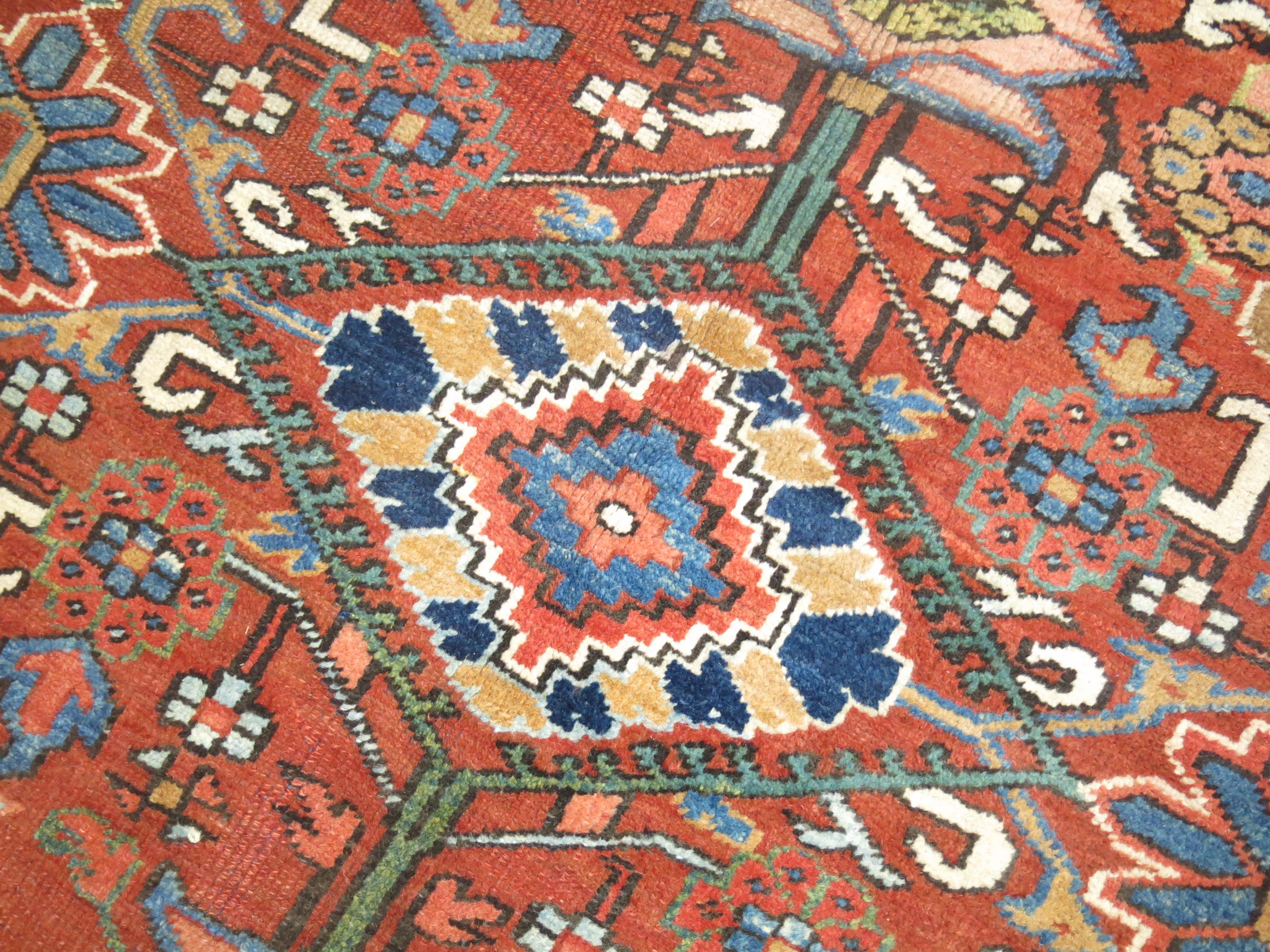 A room size Persian karadja weave heriz rug . Orangy-red field, navy border. Accents in light green, sky blue. Compelling all-over design.

8'11'' x 10'8''

Heriz carpets are beloved for their versatility. Their geometry complements modern