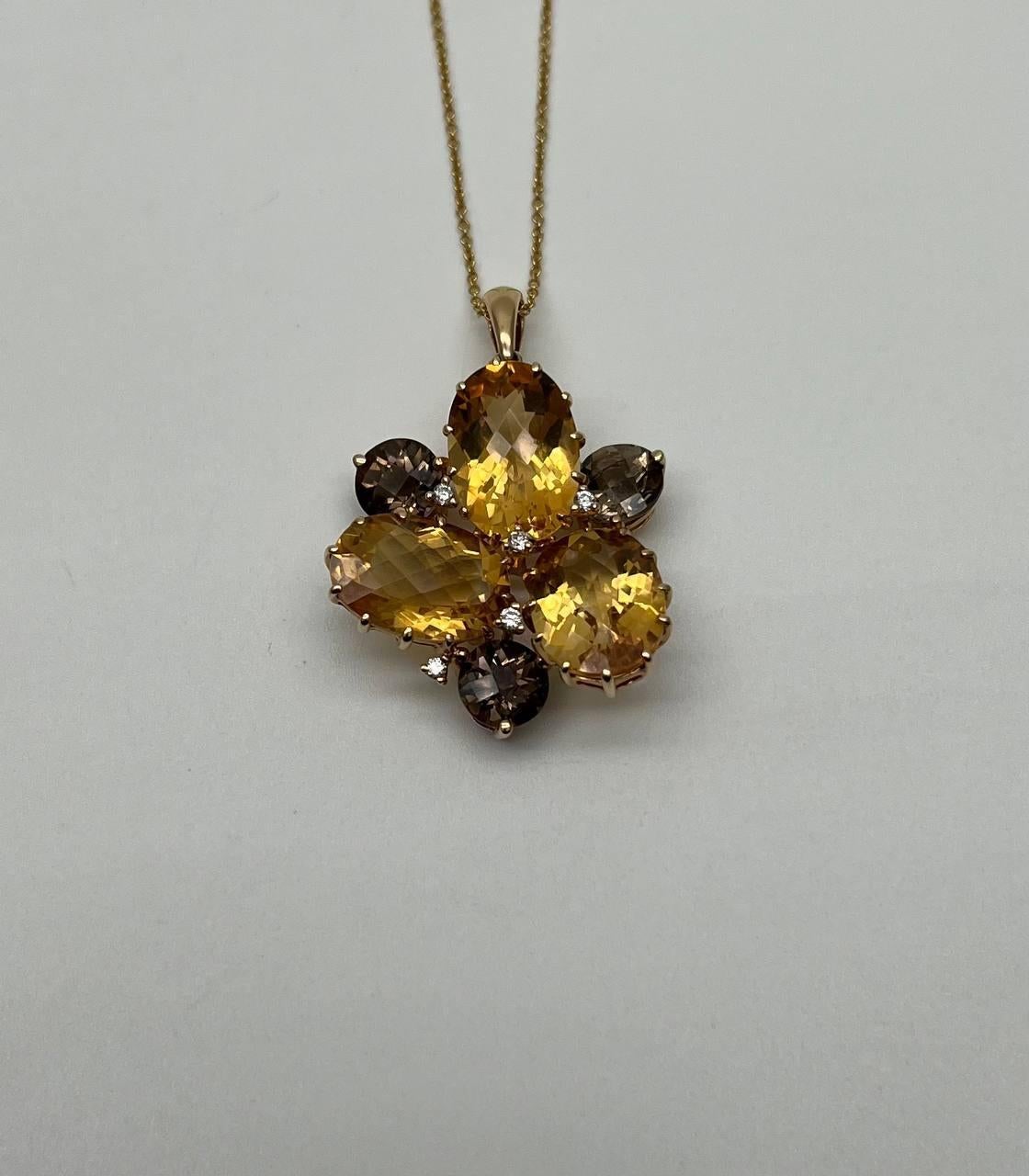 Pendant necklace featuring a floral motif with faceted orange citrines and brown smoky quartz. Set in a gold setting with a delicate chain.
14K Yellow Gold. 0.15 CTW Diamonds. Natural Smoky Quartz & Citrines.