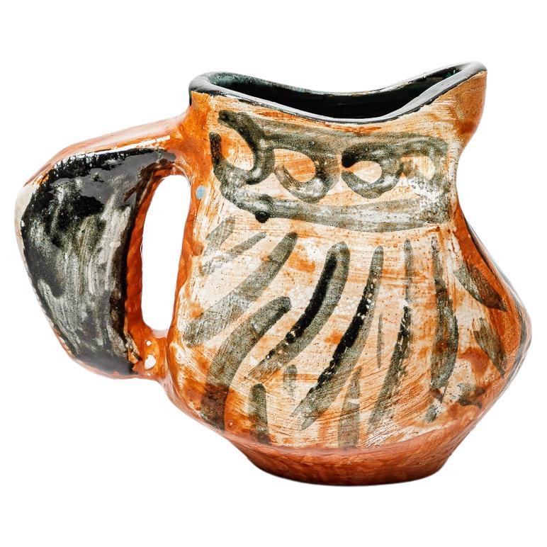 Orange and black glazed ceramic pitcher, circa 1950-1960. For Sale