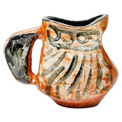 Orange and black glazed ceramic pitcher, circa 1950-1960.