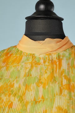 Orange and green flower print with sunray pleats and chiffon neck Circa 1960's