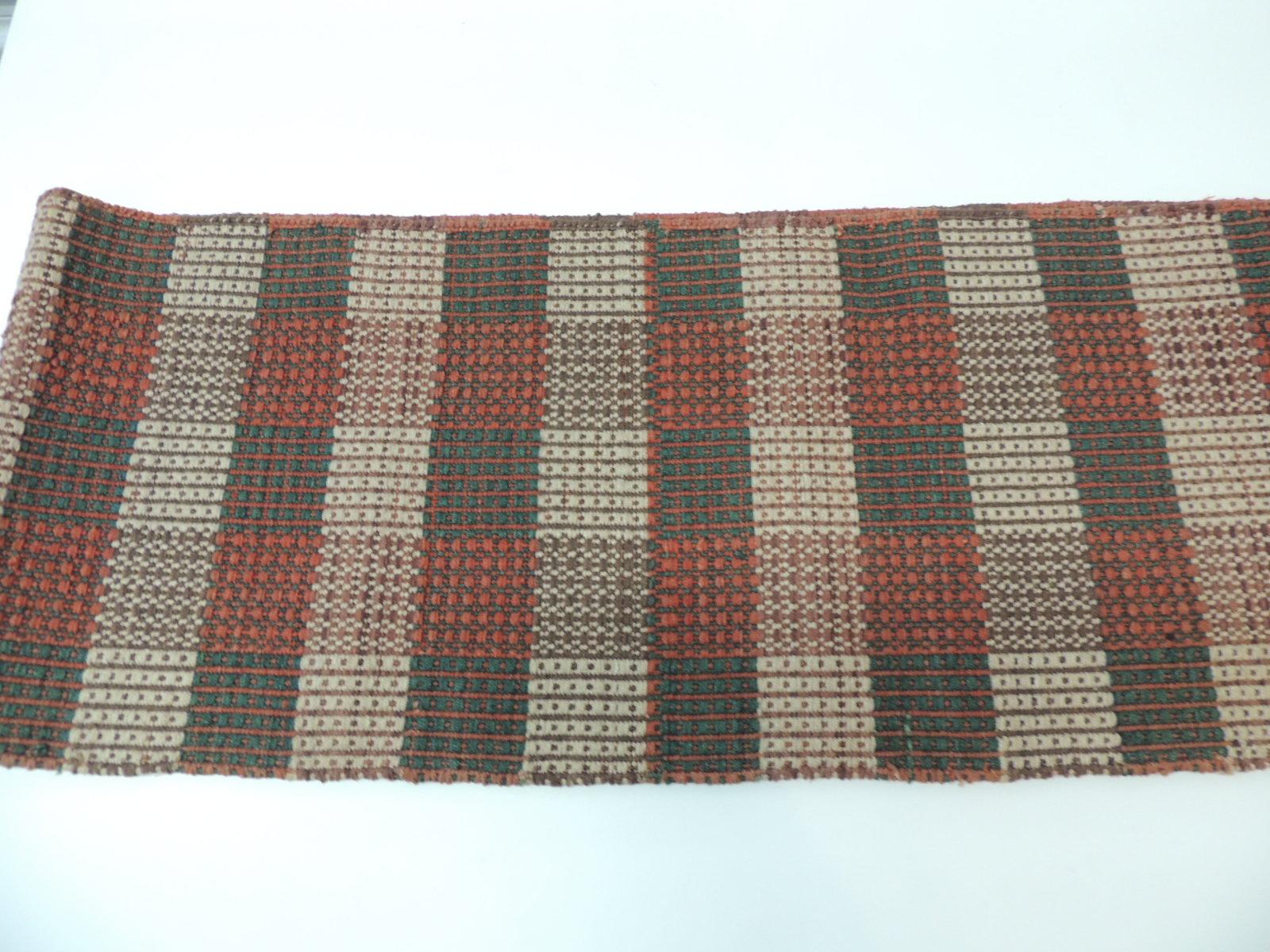 Orange and green woven table runner with small handknotted fringes.
Size: 12.5