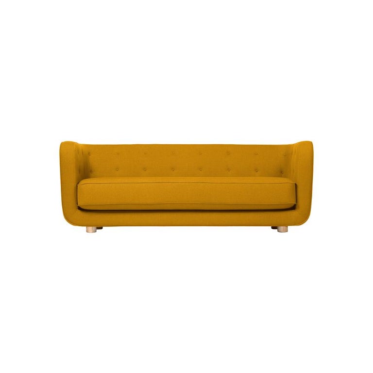 Orange and natural oak Raf Simons Vidar 3 Vilhelm sofa by Lassen
Dimensions: W 217 x D 88 x H 80 cm 
Materials: textile, oak.

Vilhelm is a beautiful padded three-seater sofa designed by Flemming Lassen in 1935. A sofa must be able to function
