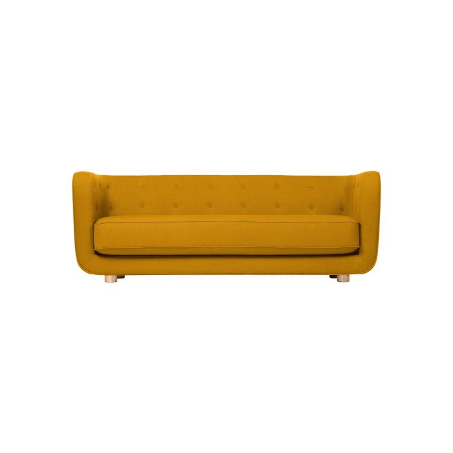 Orange and natural oak Raf Simons Vidar 3 Vilhelm sofa by Lassen
Dimensions: W 217 x D 88 x H 80 cm 
Materials: Textile, oak.

Vilhelm is a beautiful padded three-seater sofa designed by Flemming Lassen in 1935. A sofa must be able to function