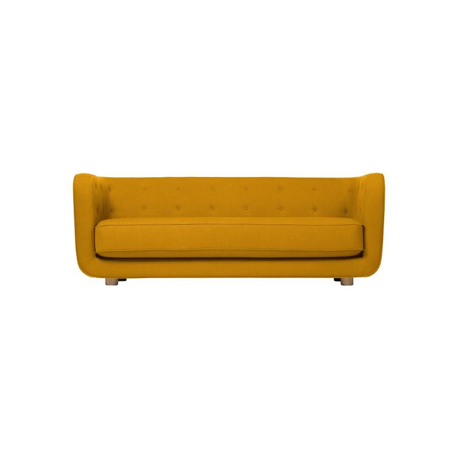Orange and smoked Oak Raf Simons Vidar 3 Vilhelm sofa by Lassen
Dimensions: W 217 x D 88 x H 80 cm 
Materials: Textile, oak.

Vilhelm is a beautiful padded three-seater sofa designed by Flemming Lassen in 1935. A sofa must be able to function in