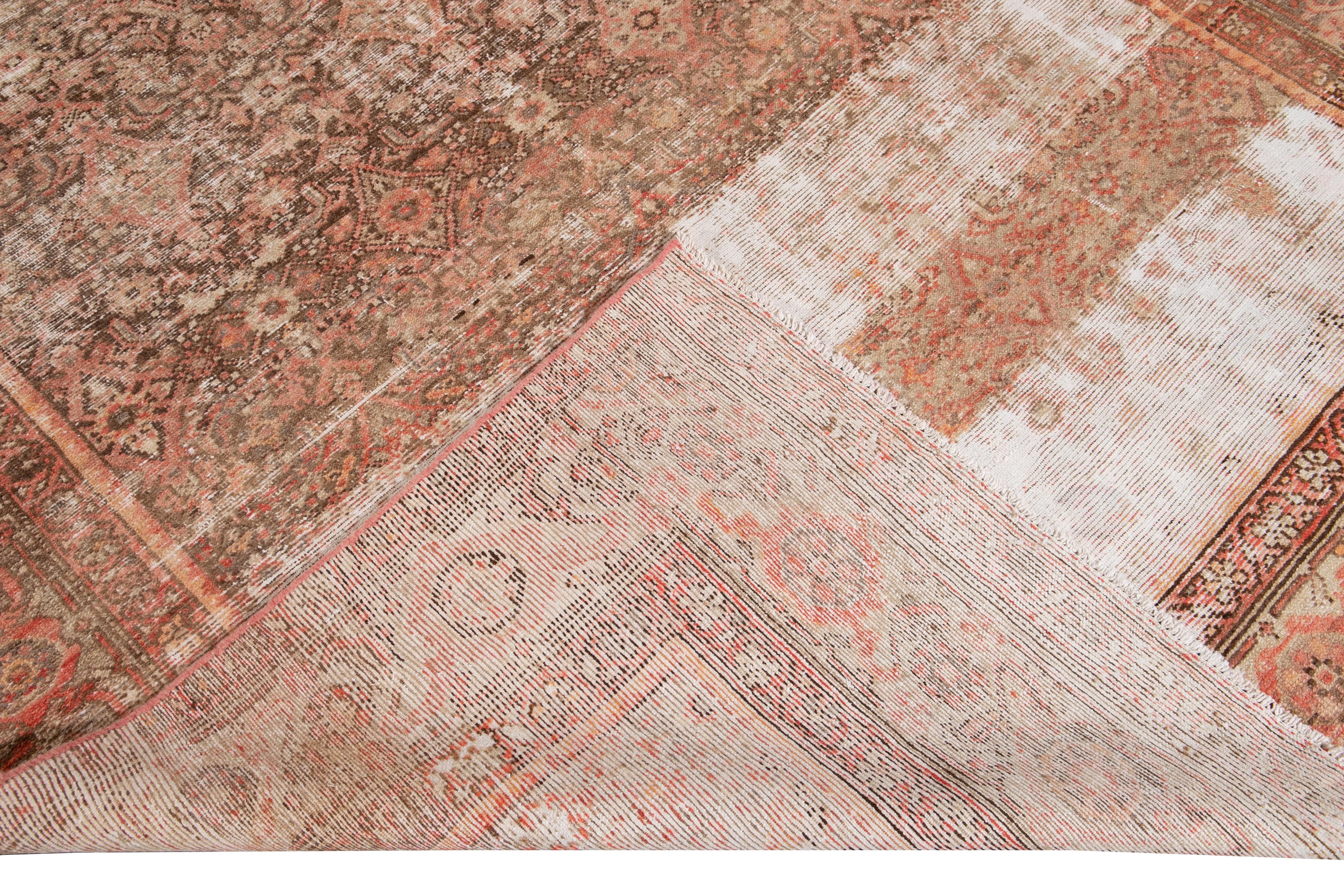 Beautiful antique Malayer hand knotted wool runner with an orange and peach field. This Malayer rug has accents of ivory and brown in an all-over gorgeous geometric floral distressed design.

This rug measures: 6'5
