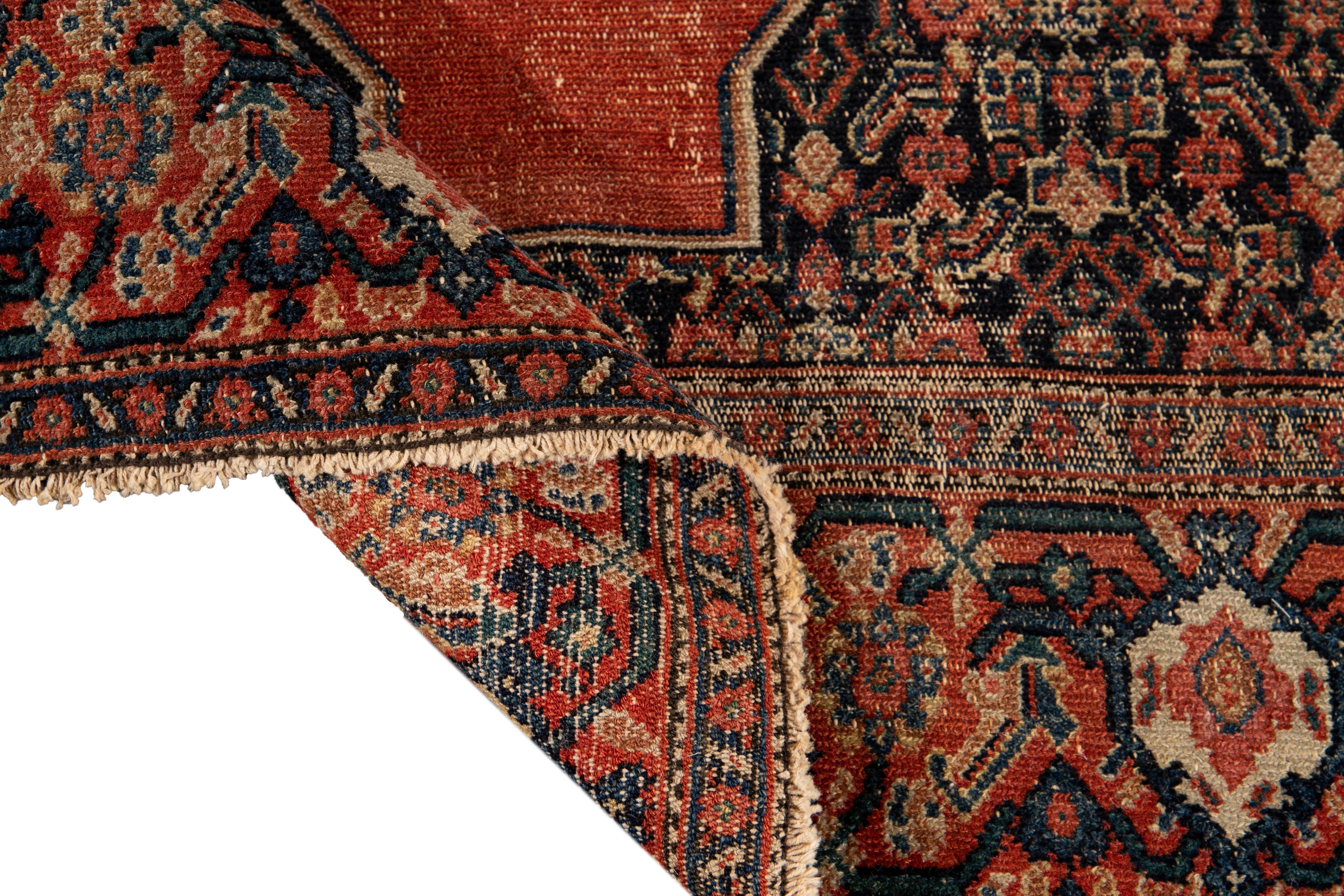 Beautiful antique Sene Persian hand knotted wool rug with a blue and orange field. This Sene rug has multi-color accents in a gorgeous all-over geometric floral medallion Distressed design.

This rug measures: 4'5