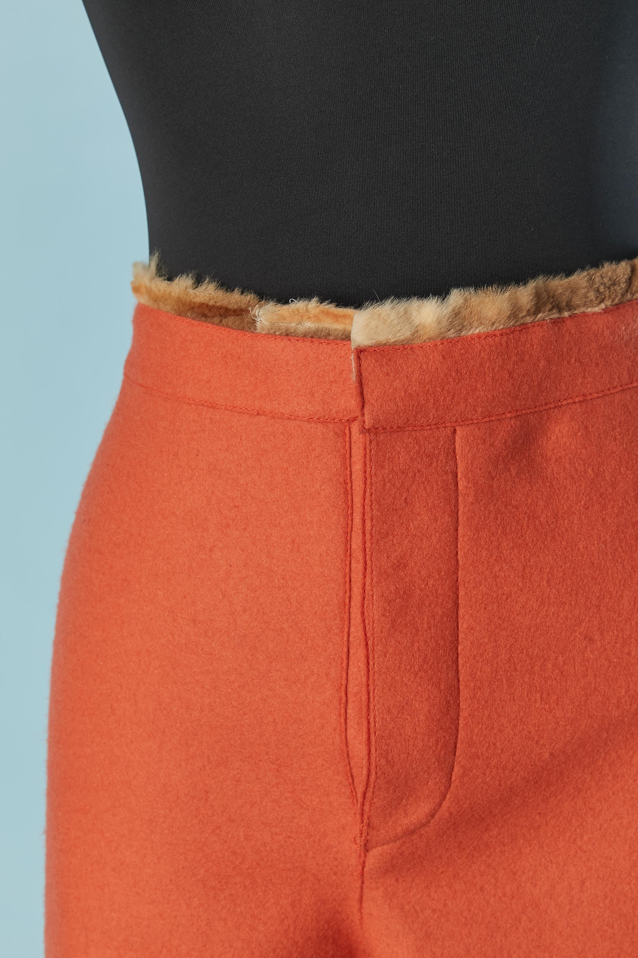 Orange boiled wool trouser with furs edge waist and bottom. Invisible snap covered with fabric on the top middle front + button and button hole closure 
SIZE 42 (It) 38 (Fr) M 