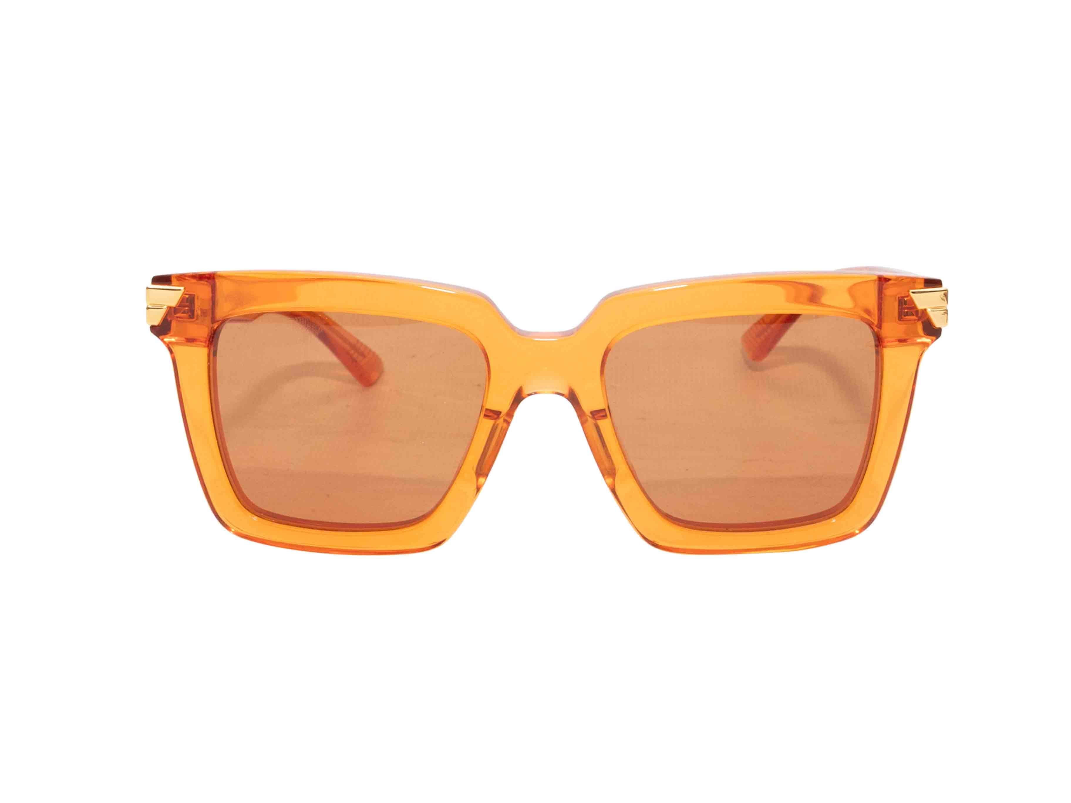 Occhiali da sole in acetato traslucido arancione di Bottega Veneta. Lenti colorate arancioni. Altezza 2,25
