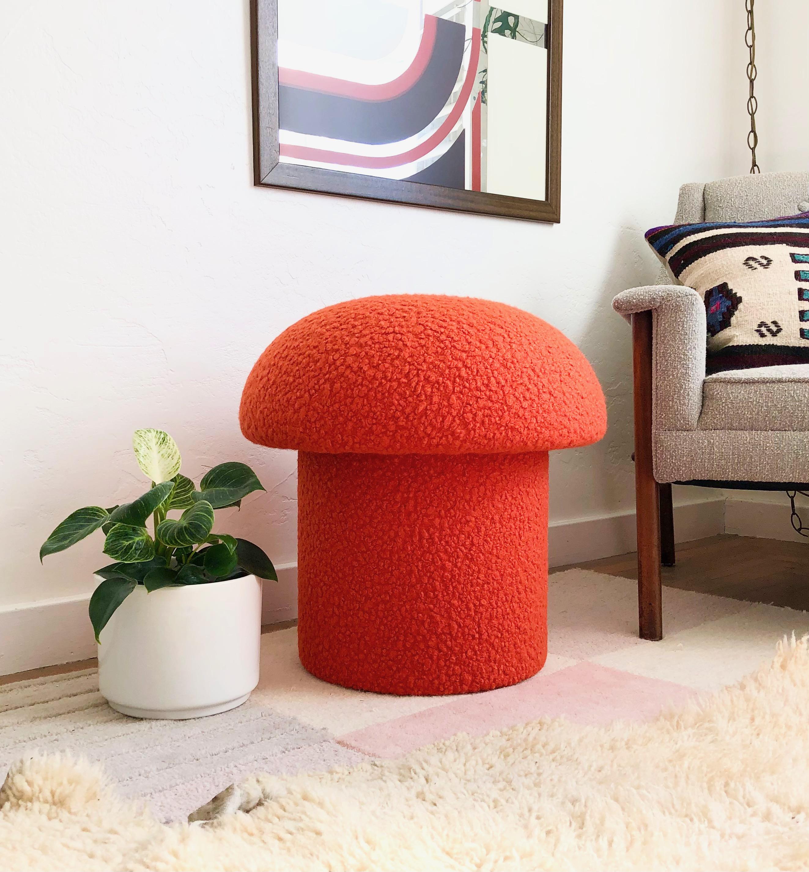 A handmade mushroom shaped stool, upholstered in an orange colored curly boucle fabric. Perfect for using as a footstool or extra occasional seating. A comfortable cushioned seat and sculptural accent piece.
Mushroom ottomans are made to order,