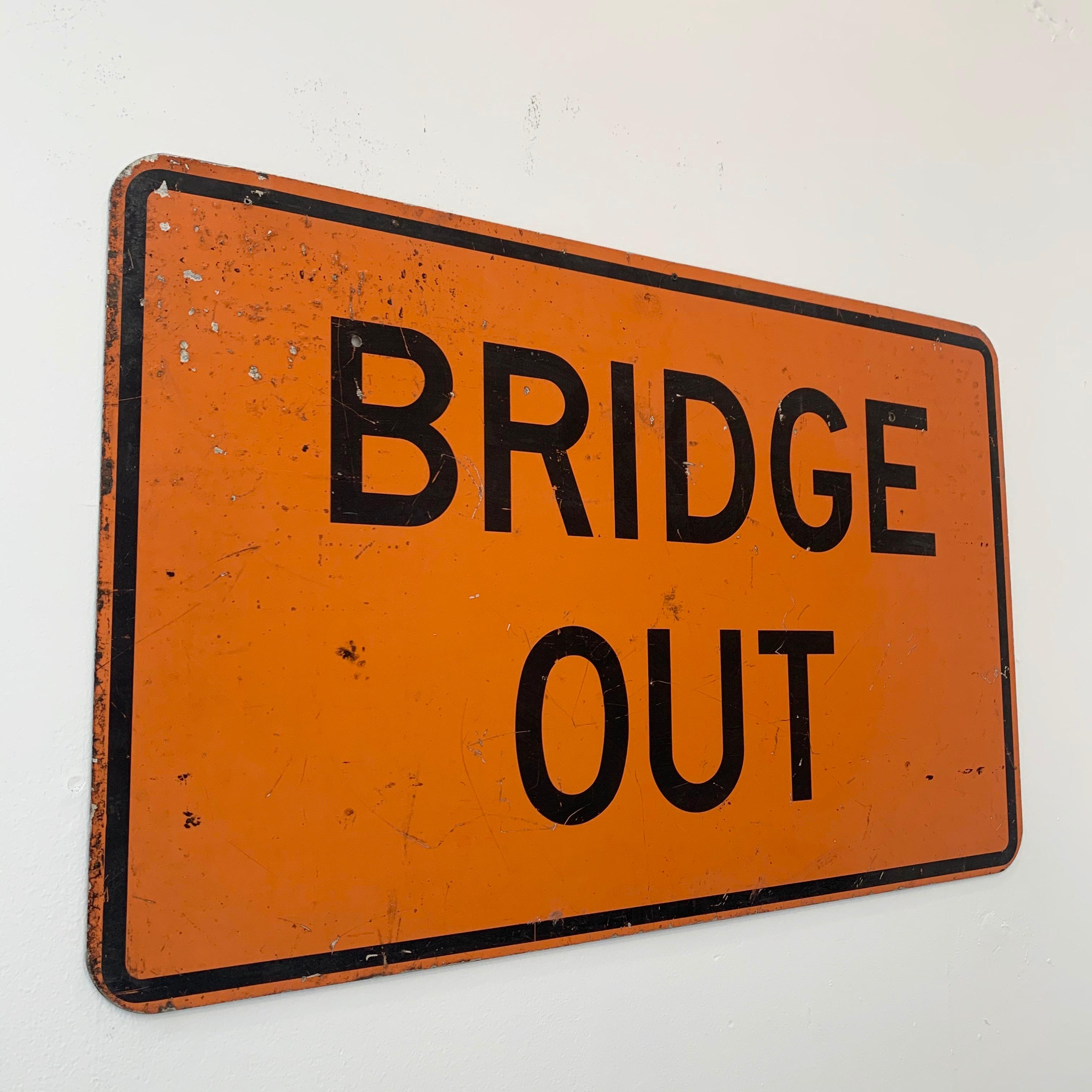 Super cool vintage metal 'BRIDGE OUT' sign from the East Coast. Measures: 4 feet wide. Orange sign with black lettering. Bullet holes and road rash to sign.