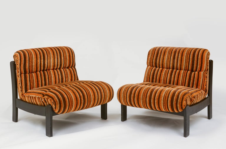 Orange, brown pair wood lounge chairs with Original 70's Fabric, France 1970's

Very comfortable large lounge chairs. Wooden details that supports the cushions. Original fabric. Imported from France.