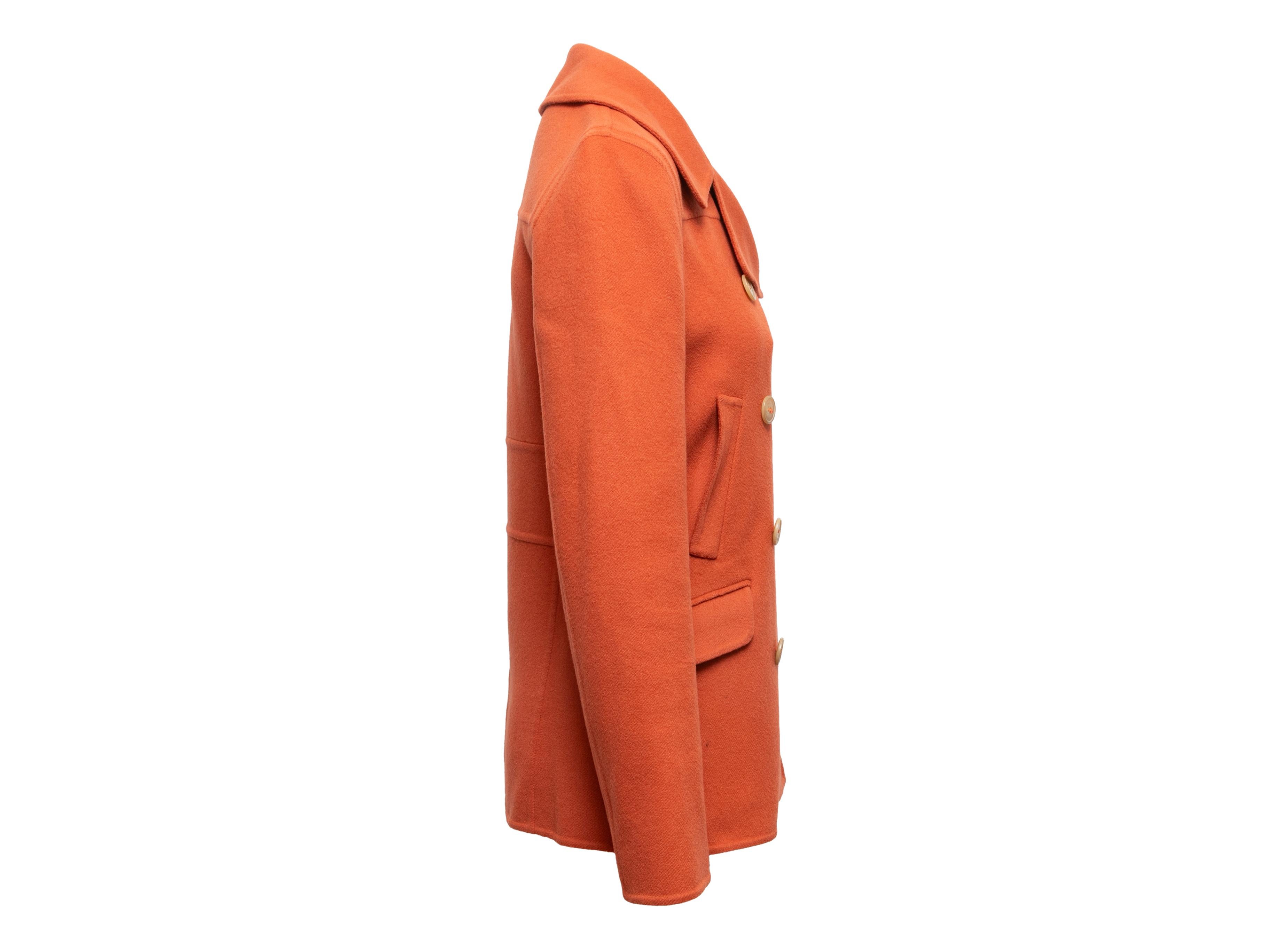 Orange cashmere double-breasted peacoat by Calvin Klein Collection. Notched lapel. Dual hip pockets. Button closures at front. 30